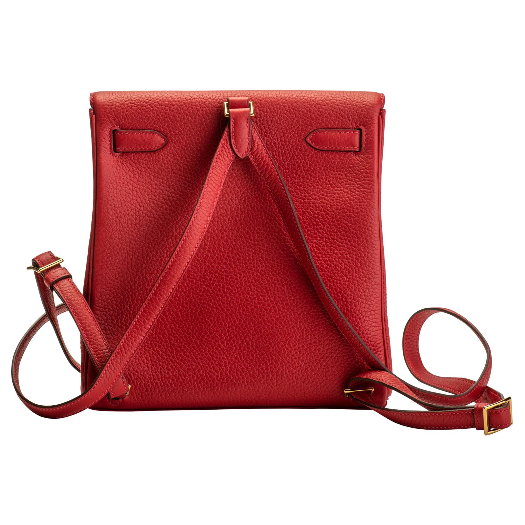 Hermès Kelly a Dos backpack in rouge casaque leather with goldtone hardware. Date stamp D for 2019. Brand new with full set: dust cover, booklet, box, ribbon, and shipping bag.