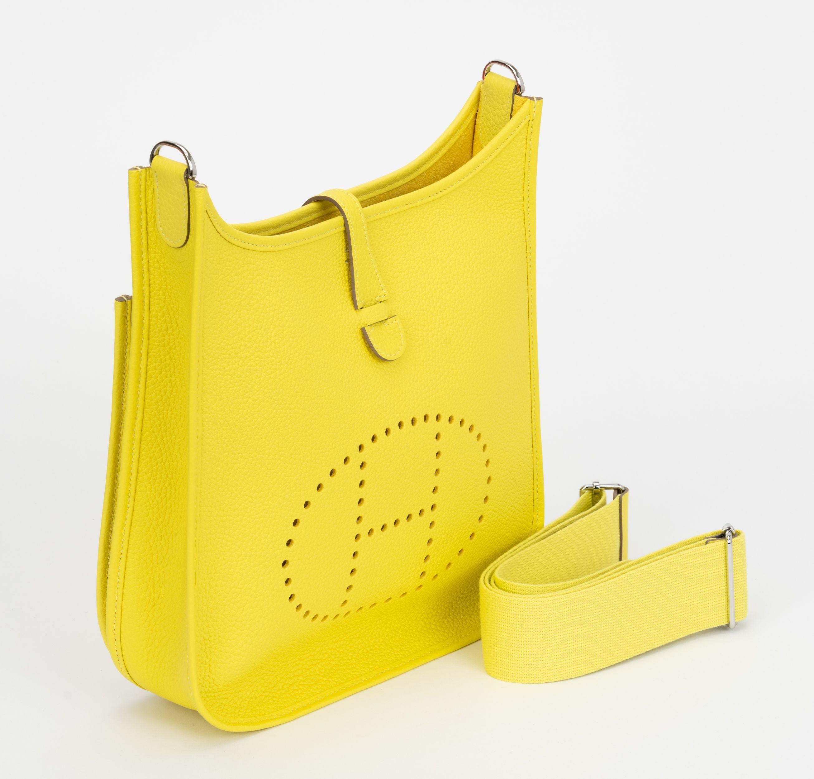 Hermès new lime yellow togo leather medium (PM) Evelyne with palladium hardware. Adjustable shoulder strap, can be worn cross body. Date stamp U in a square, 2022. Comes with original duster, shoulder strap, box.