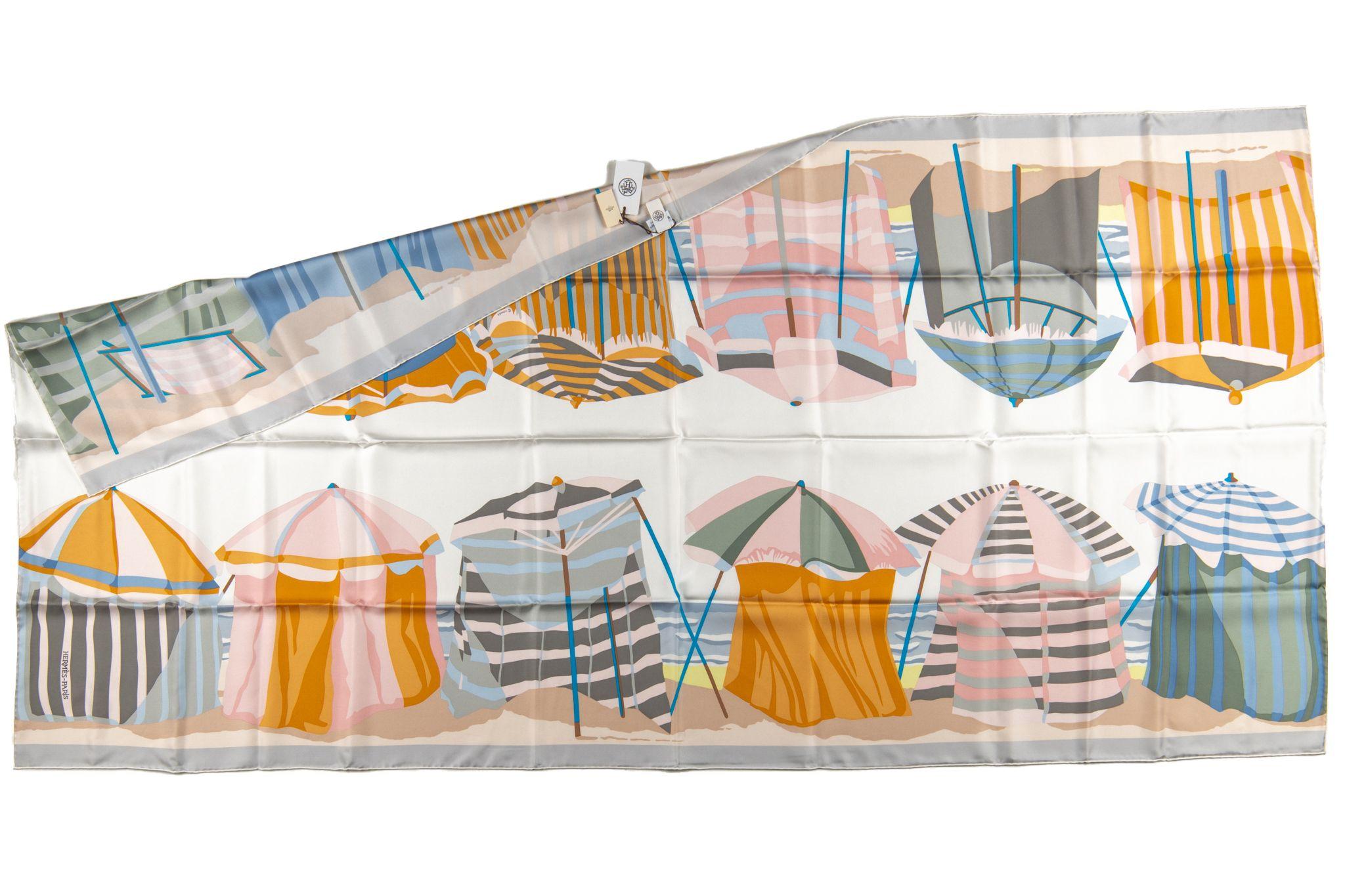 Hermes Charmes des Normandes Scarf. Features colorful beach tents on beaches of Normandy. Rectangle shape allows it to be worn as a stole, top or neck scarf. Comes without box.
