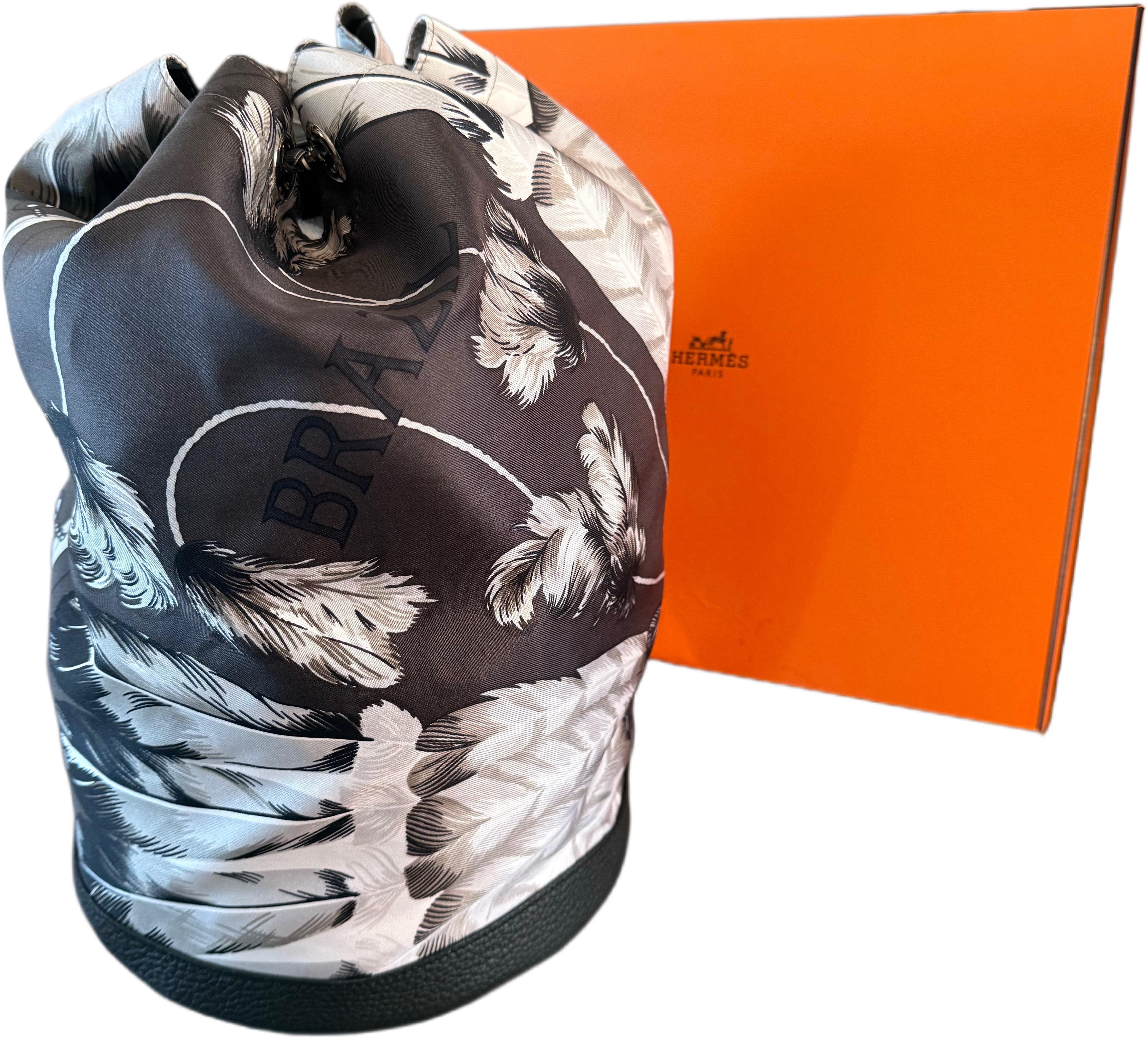 Rare brand new with box Hermes limited edition unisex silk and leather backpack ! From the 2014 collection. Features feather prints and Brazil printed throughout. Neutral colors of gray, white and navy for anytime of year. Black pebbled leather