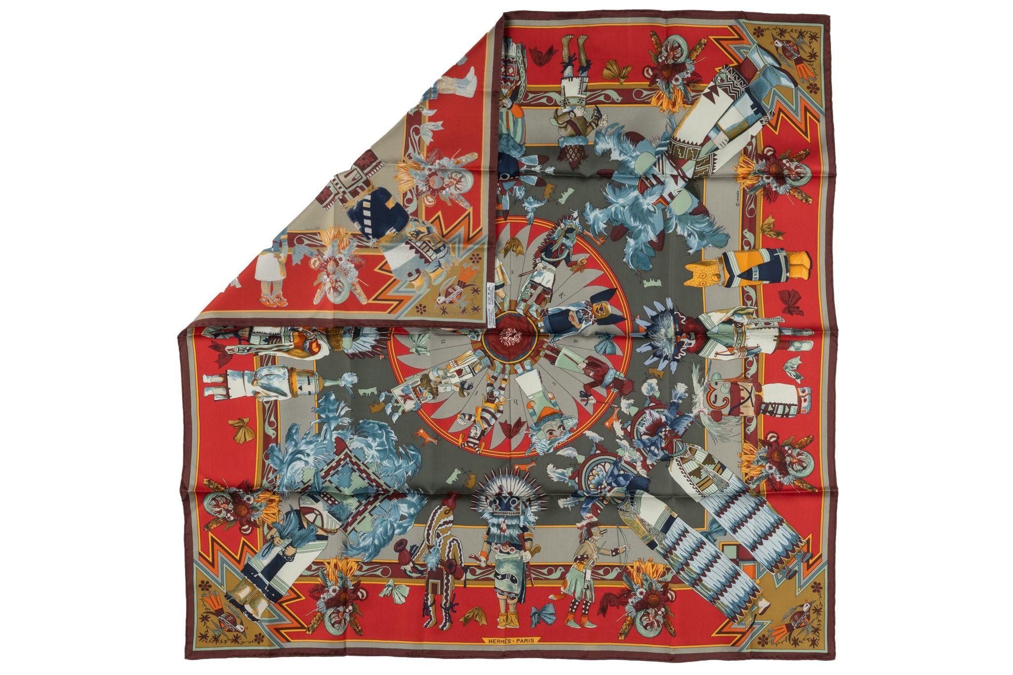 This Hermès Kachina 100% Silk Scarf is designed by Kermit Oliver. Unusual and collectible colo combination taupe and red. Hand rolled edges, new condition.