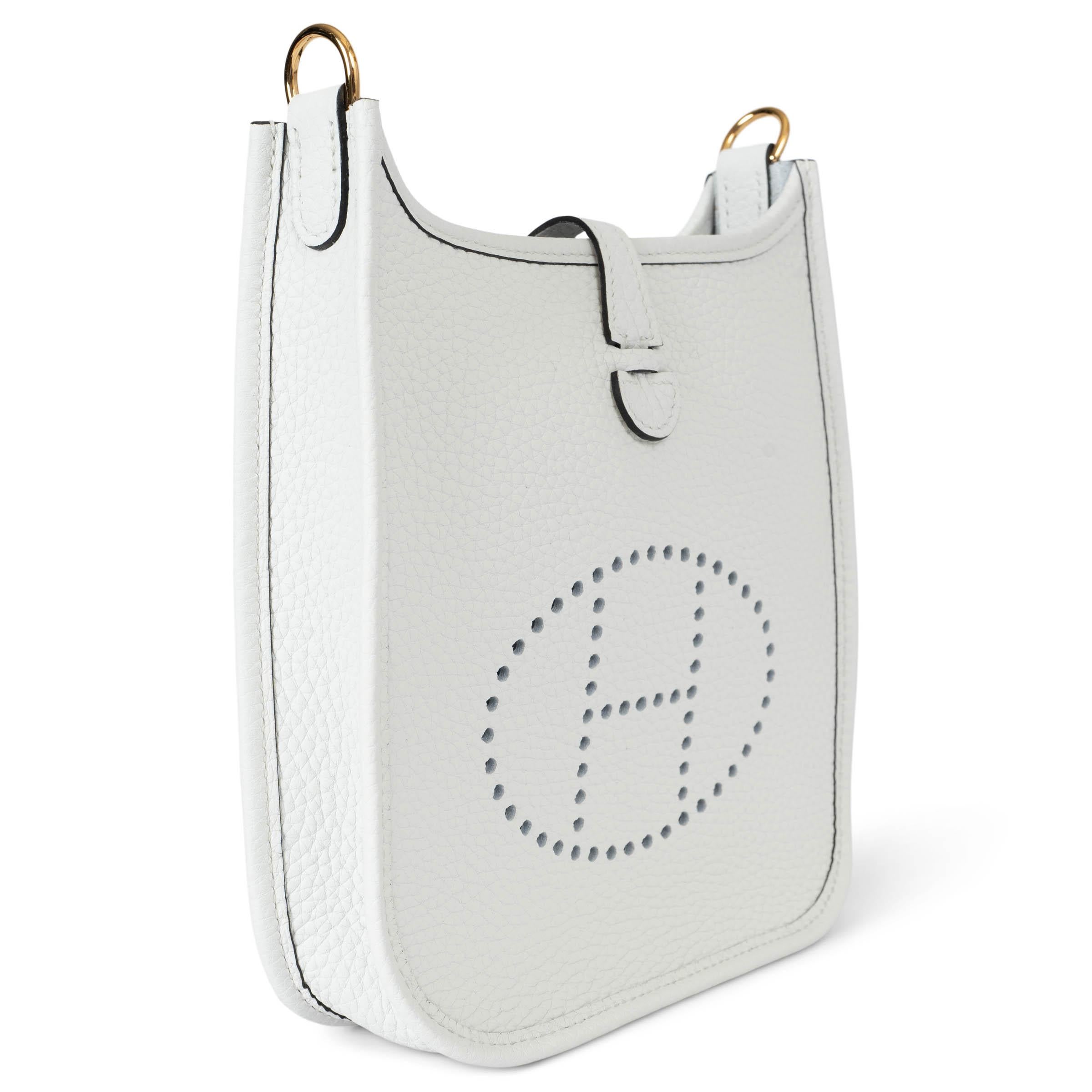 100% authentic Hermès Evelyne 16 TPM Crossbody Bag in New White Taurillon Clemence leather with a uni wool sangle strap in New White, perforated leather 