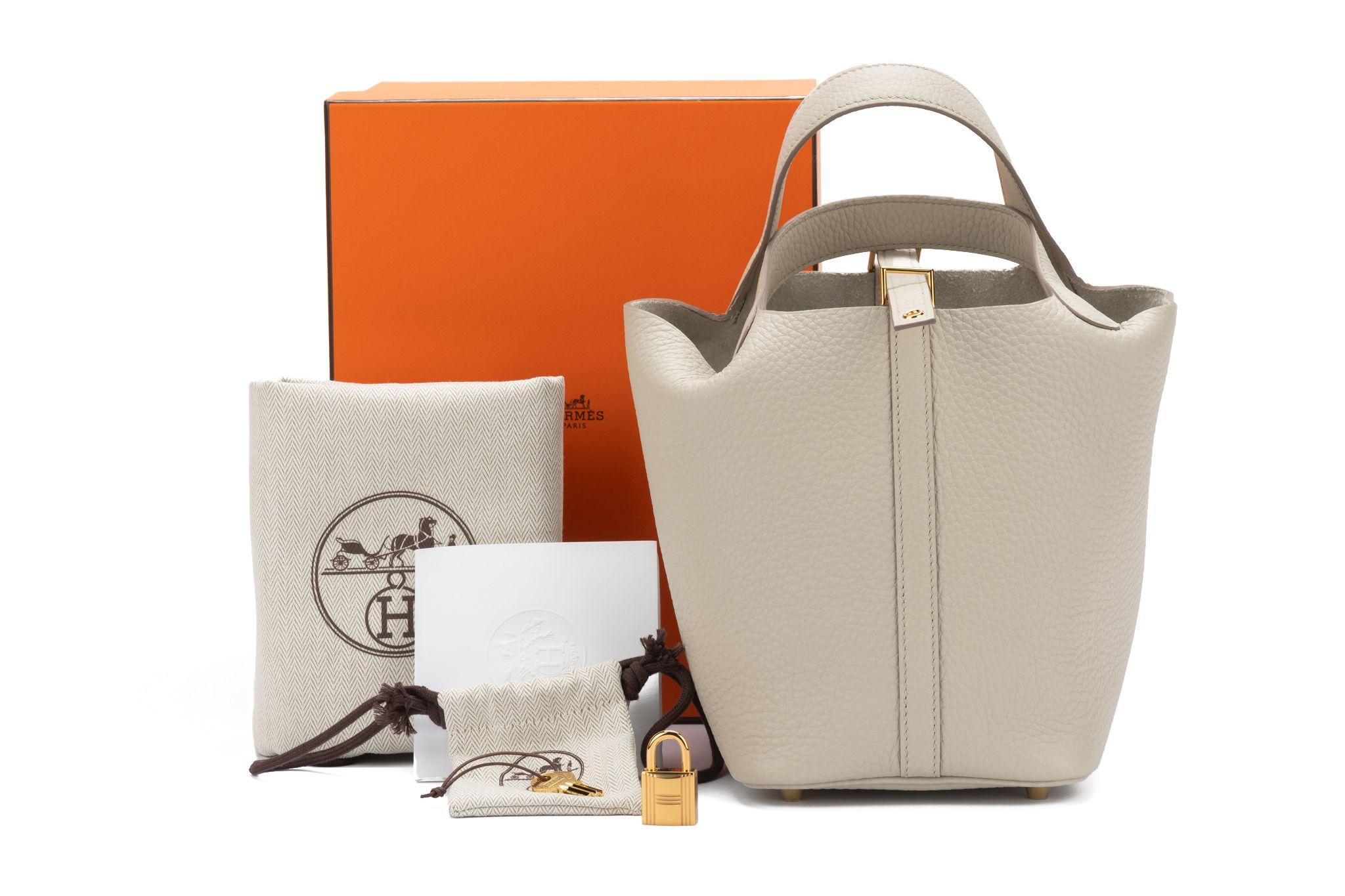 Hermès Picotin Lock bag in clemence leather and the color beton. The Hardware is gold. The bag is brand new and comes with the lock, original dustcover, booklet and box.