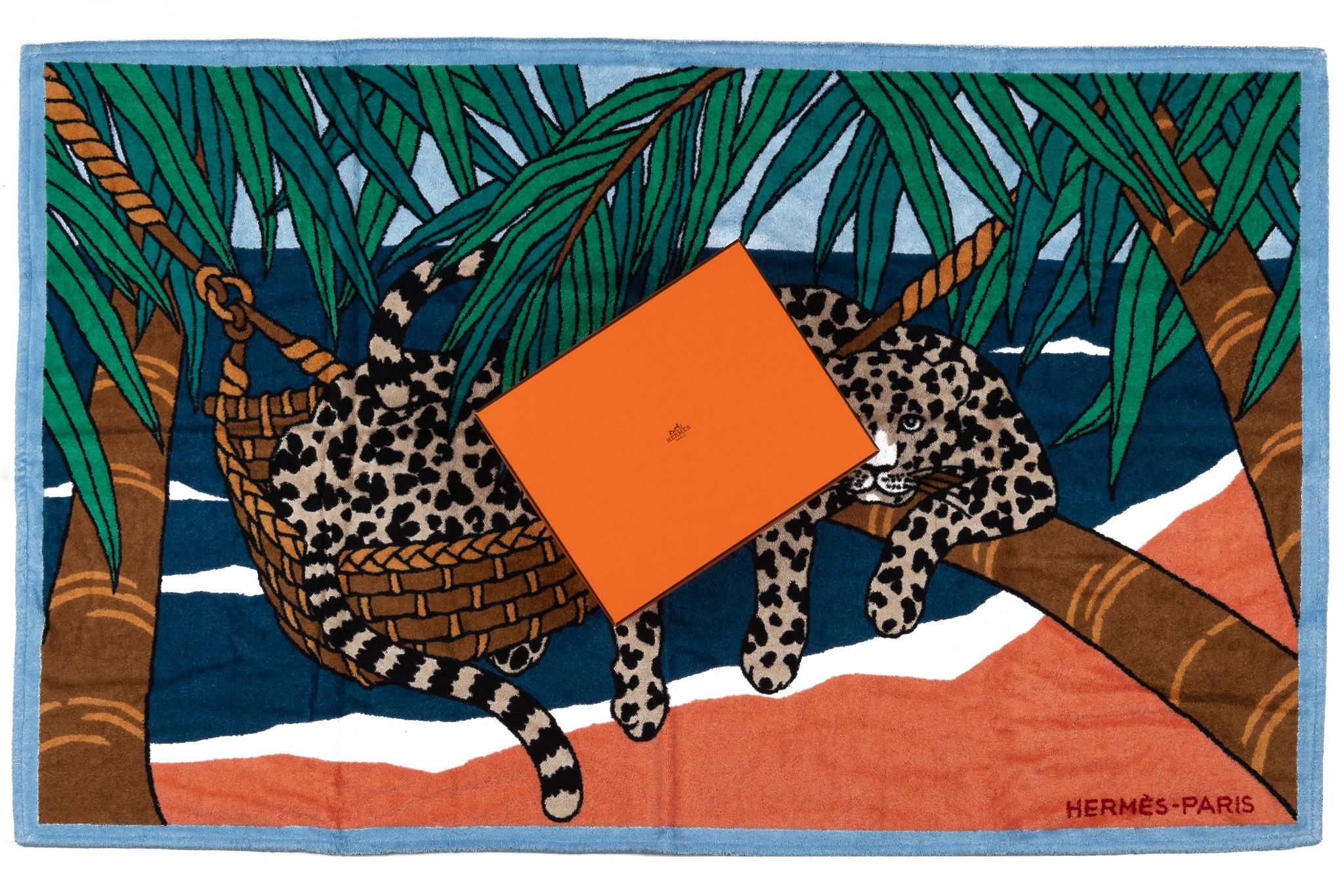 Hermès Leopard Beach Towel in green and blue. The pattern shows two blue leopards in a hammock. The item is in new and comes with the box.