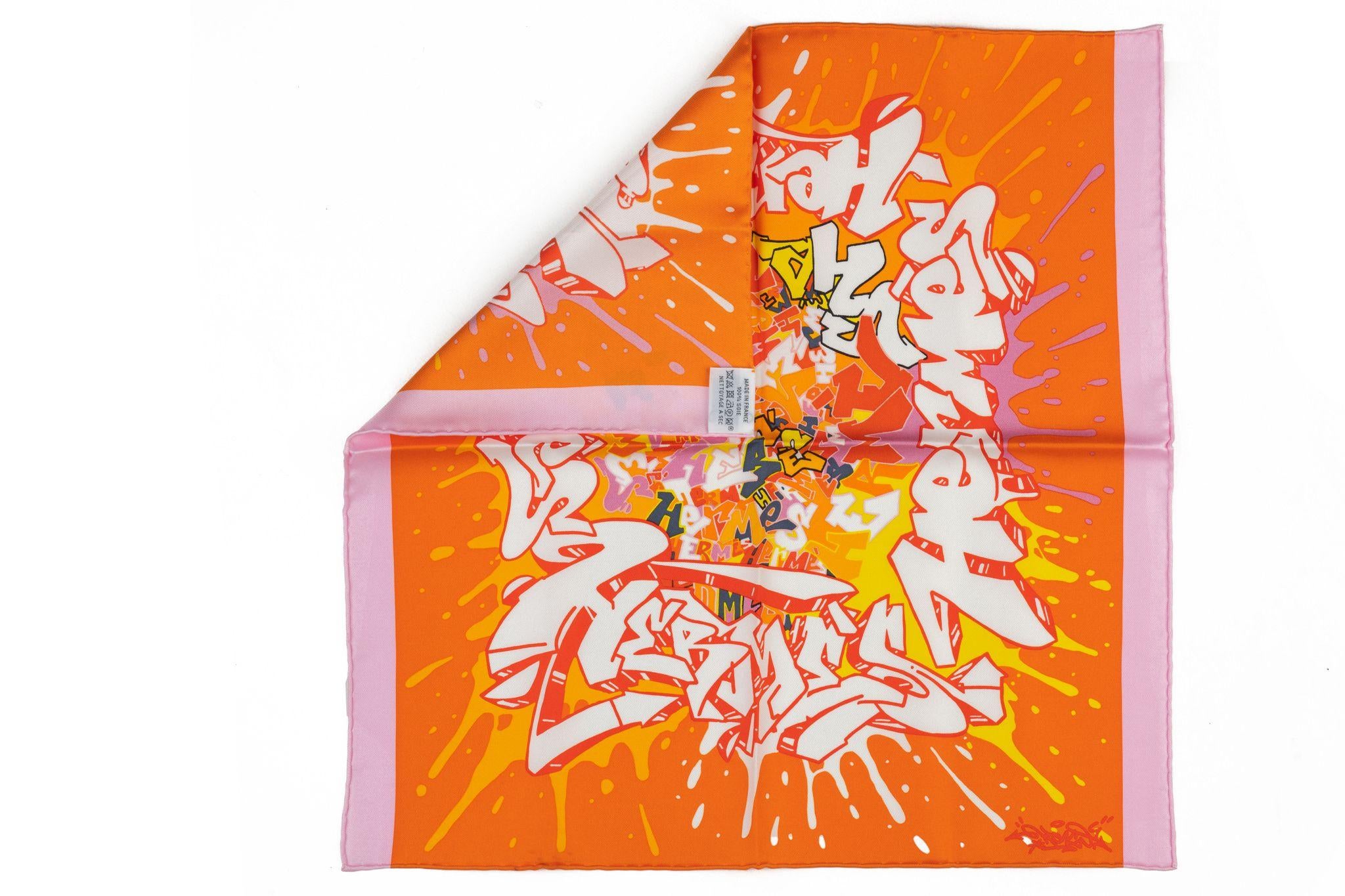 Hermès brand new collectible orange pink graffiti silk gavroche. Hand oiled trim. Comes with original box.
