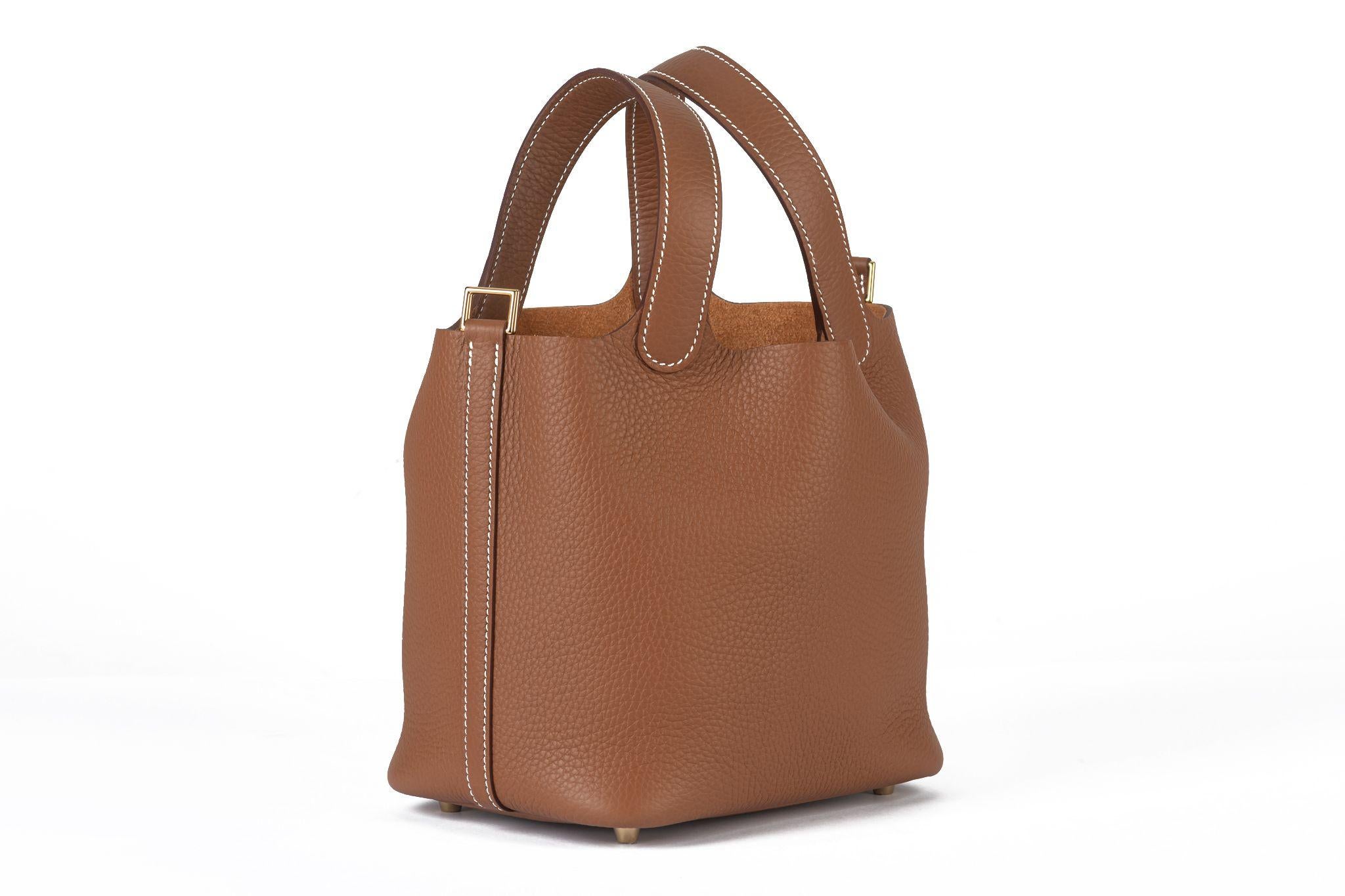 Questa borsa Hermès Picotin Lock PM è realizzata in pelle di vitello Clemence di colore marrone, con manici in pelle e una tracolla che può essere chiusa con un lucchetto placcato oro.
Altezza del manico 4,75