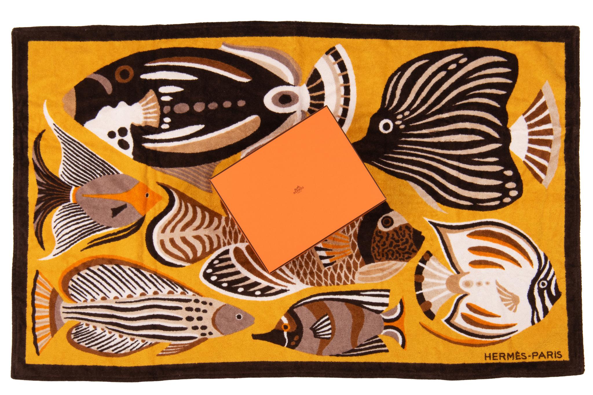 Serviette de plage Hermès Fish. Le motif représente plusieurs poissons de différentes couleurs. La pièce est neuve et livrée dans sa boîte d'origine.