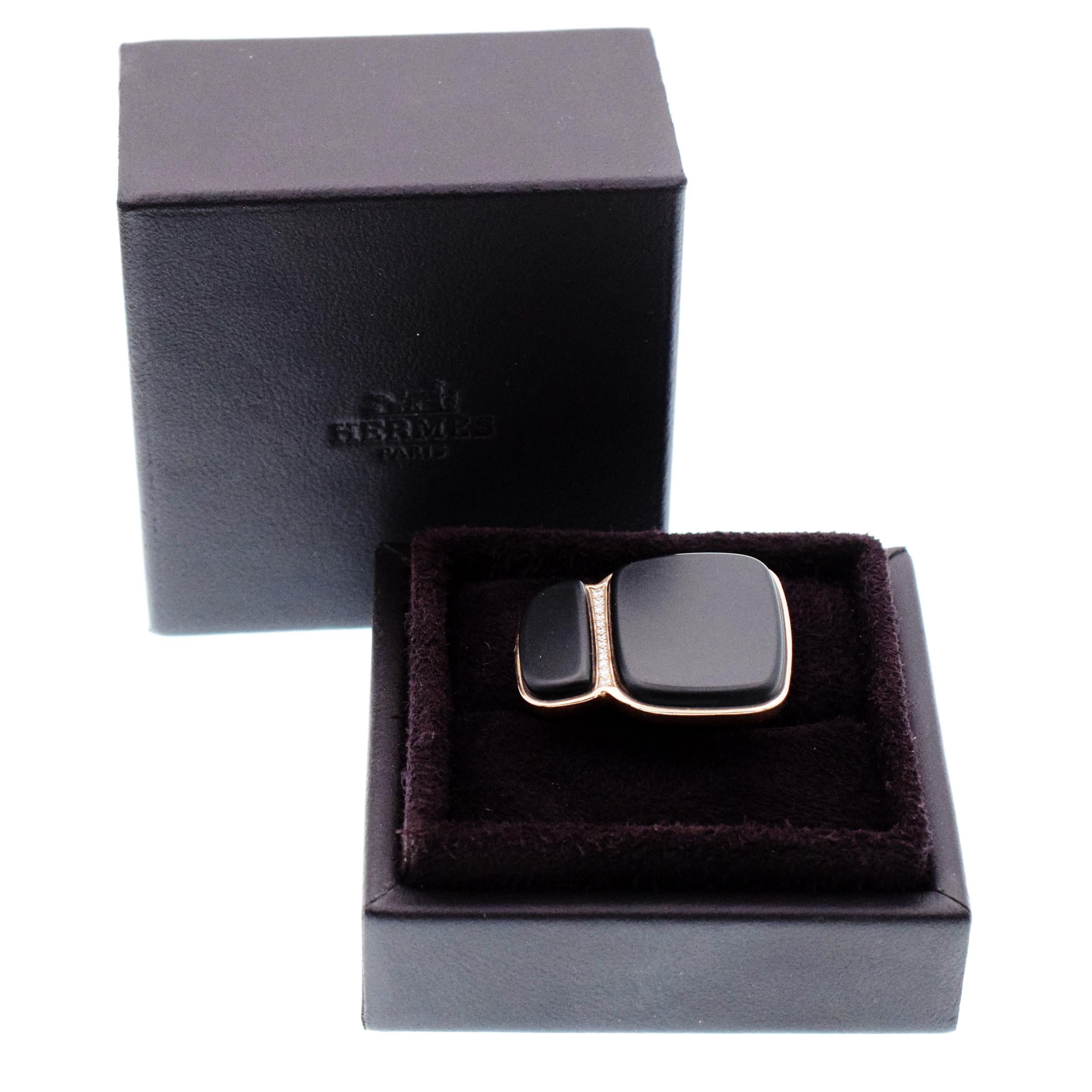 Hermes Niloticus Lumière black spinel and diamond
ring in 18k rose gold. The ring features two
opaque black spinel stones separated by a row of 13 round brilliant cut pave set diamonds. Inscribed: Hermes,
Au750, 52, Made in France,
21APxxxxx Stamped