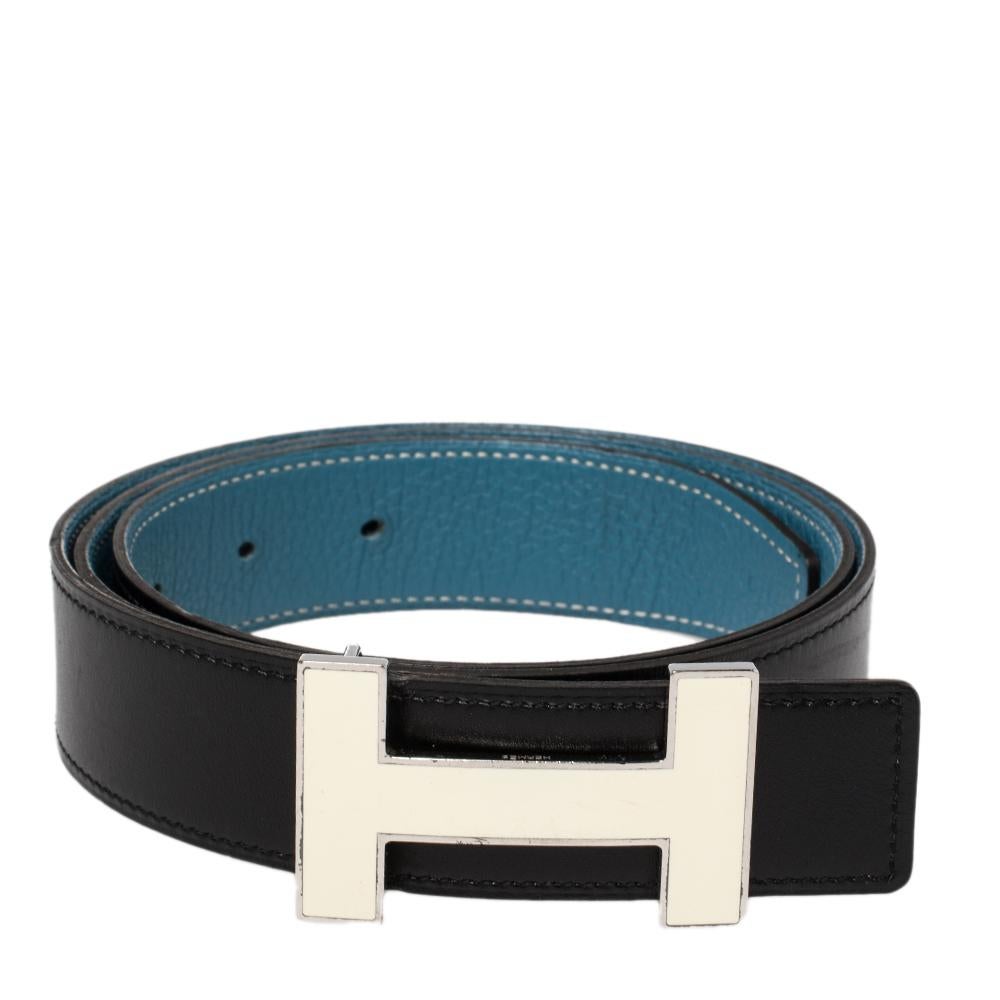 A classic add-on to your collection of belts, this Hermes piece has been crafted from Togo and Chamonix leather. It is reversible with a black shade on one side and blue on the other. It is topped with an H buckle in palladium-plated metal. This