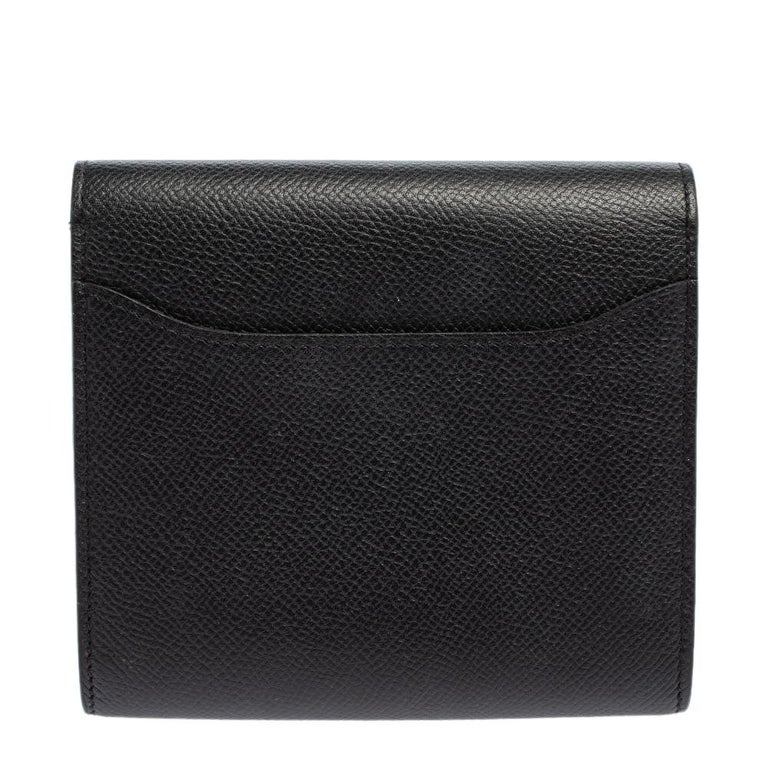 The Constance wallet from Hermes is nothing less than a wondrous work of art. It is crafted with Noir Epsom leather and is secured by a gold-tone 'H' tab closure. It has undergone the excellent work of talented artisans, with every stitch giving