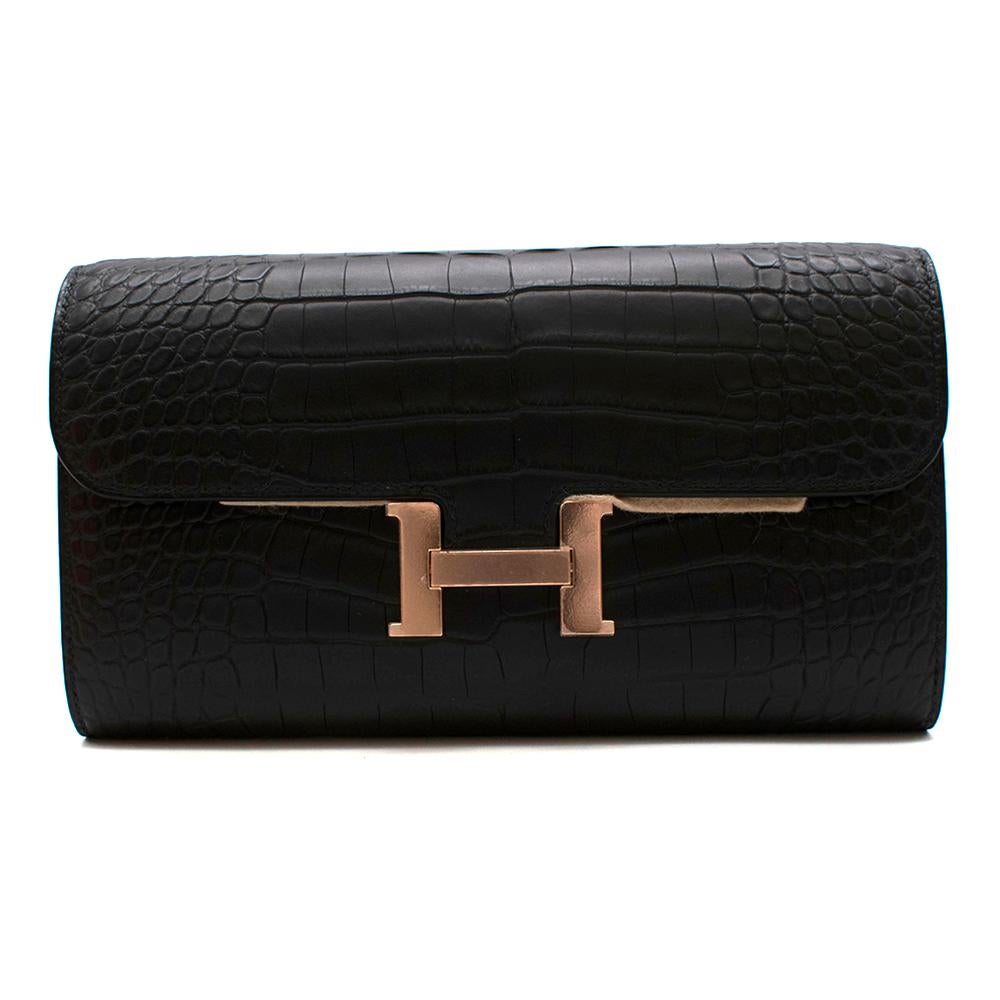 Hermes Noir Matte Alligator Constance Long Wallet To Go GHW

Launched in 1967, the Constance bag - named after the creator's daughter - gives its shape to the line of wallets revealing the ingenious H-shaped clasp: the central bar lifts up and