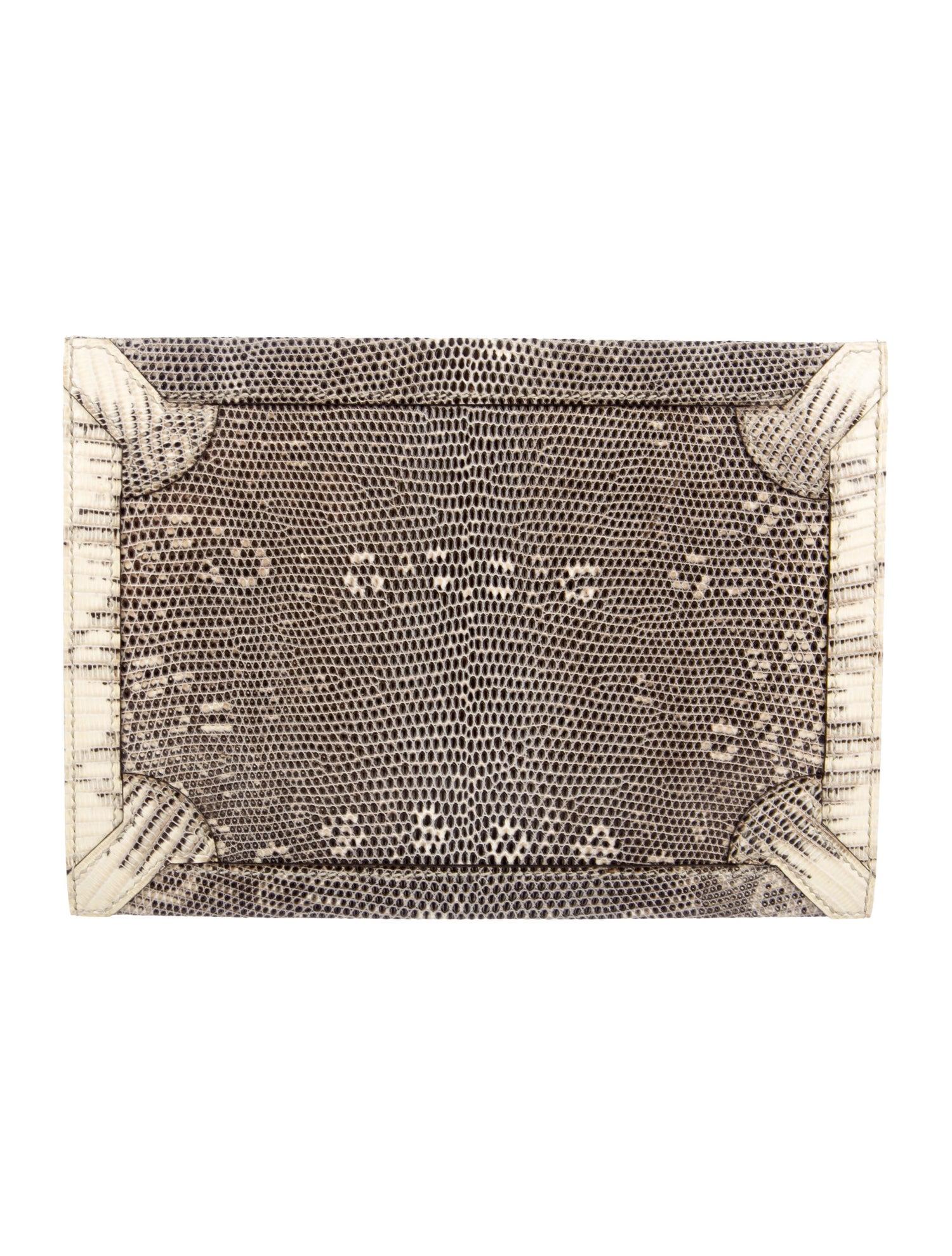 Lizard 
Palladium-plated hardware
Leather lining
Push-lock closure
Made in France
Measures 8