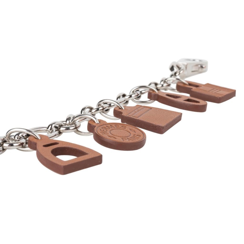 Mightychic offers a guaranteed authentic Limited edition Hermes Breloque Olga Amulette bag charm with Barenia leather charms.
Set on palladium link  chain.
This fabulous cahrm is no longer produced.
A collectors piece. 
Comes with signature Hermes