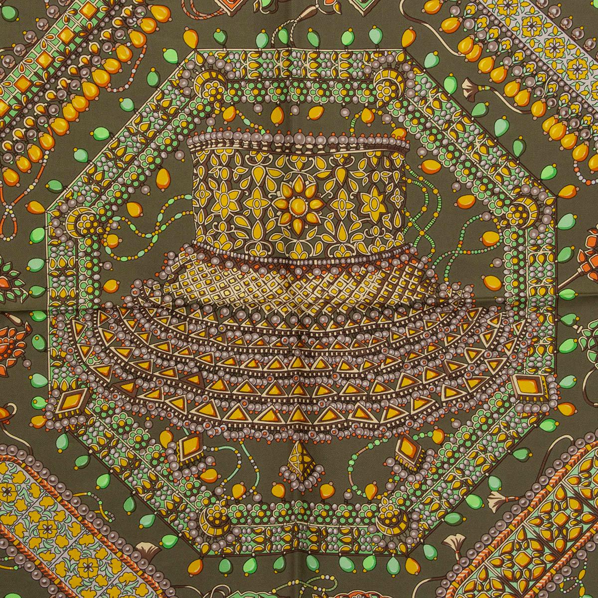 100% authentic Hermes 'Parures des Maharajas 90' scarf by Catherine Baschet in olive green silk twill (100%) with contrasting black hem and details in orange, lime green, taupe, beige and brown. Has been worn and is in excellent