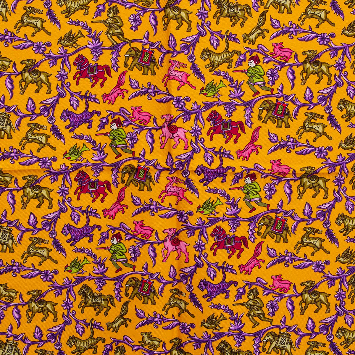 100% authentic 100% authentic Hermes 'Chasse en Inde 90' scarf by Michel Duchene in olive green silk twill (100%) with center in mango orange and details in purple, pink and raspberry. Has been worn and is in excellent condition.
Design first issued