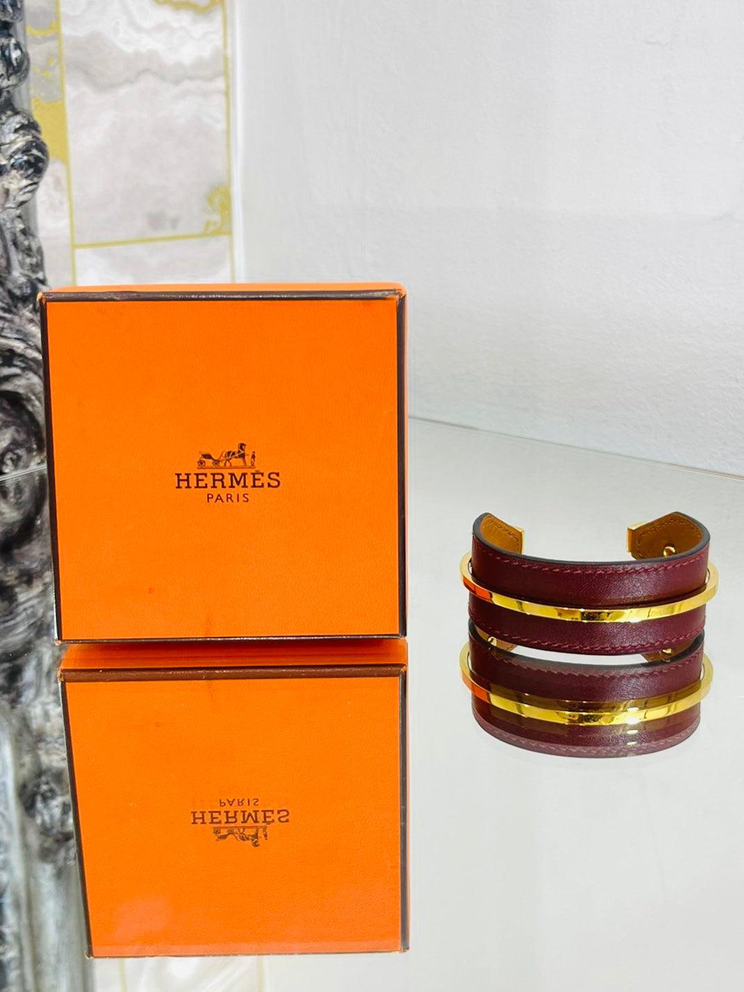 Hermes Open Cuff In Leather & Gold Plate

Burgundy leather with gold hardware. Date stamp

O in a square.

Size - One Size

Condition - Very Good (Light signs of wear)

Composition - Leather, Gold Plated Metal

Comes With - Box, Dust Bag