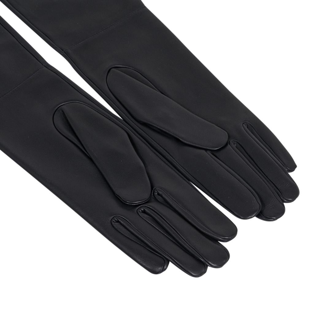 Guaranteed authentic Hermes opera length black lambskin gloves. 
Exquisitely soft and elegant.
Subtle stitch detail above the wrist.
NEW or NEVER WORN
final sale

SIZE 7

LENGTH
19.5