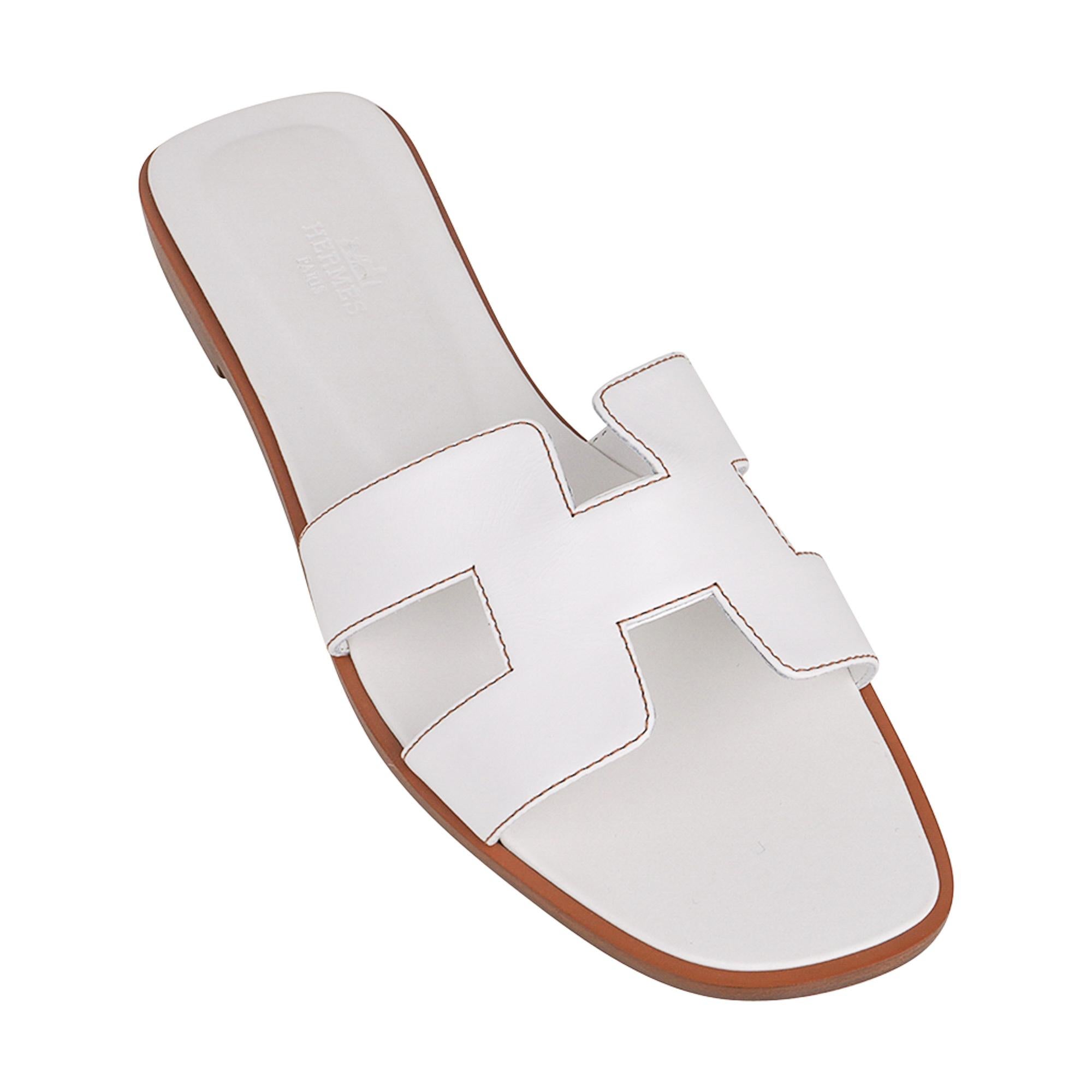 Mightychic offers a pair of Hermes Oran White leather sandals.
The iconic top stitched H cutout over the top of the foot.
This Hermes Oran slide shoe is accentuated with Havane topstitch.
Natural wood heel with leather sole.
Comes with sleepers and