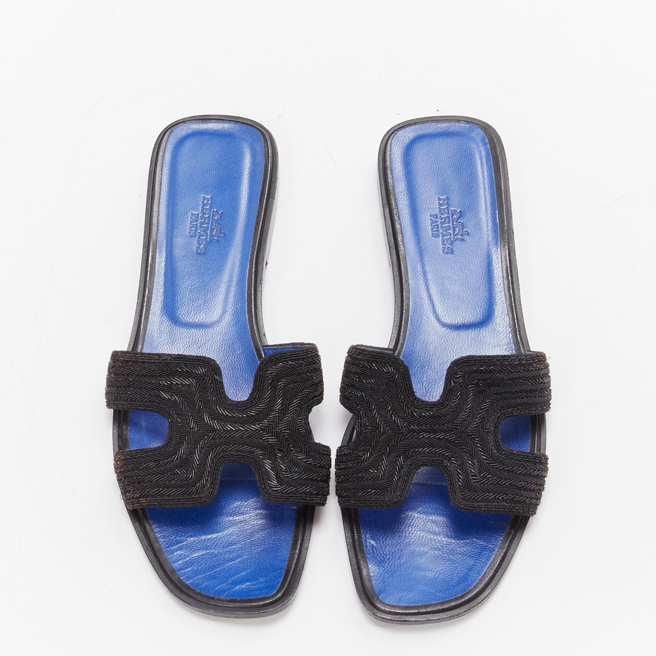 HERMES Oran H logo iconic black beaded blue insole sandals shoes EU 37
Reference: LNKO/A02099
Brand: Hermes
Model: Oran
Material: Plastic
Color: Black
Pattern: Solid
Closure: Slip On
Lining:  Leather
Made in: Italy

CONDITION:
Condition: Very good,