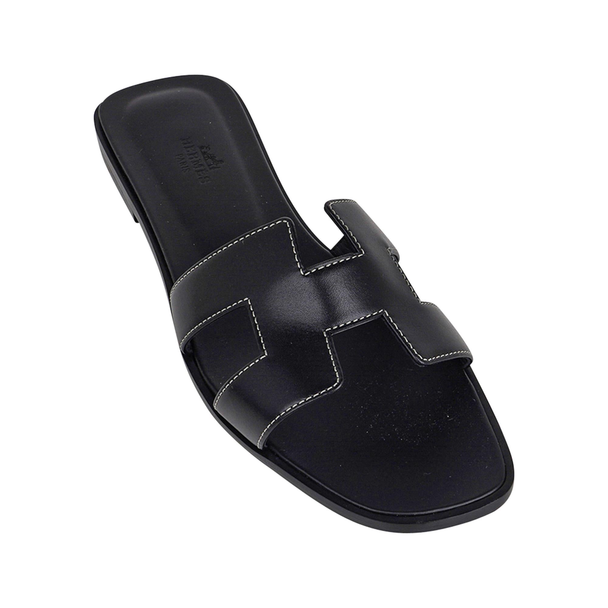 Mightychic offers a pair of Hermes Oran exquisite Black calfskin slides.
The iconic bone top stitched H cutout over the top of the foot in sublime calfskin.
Black embossed calfskin insole. 
Wood heel with leather sole. 
Comes with sleepers,