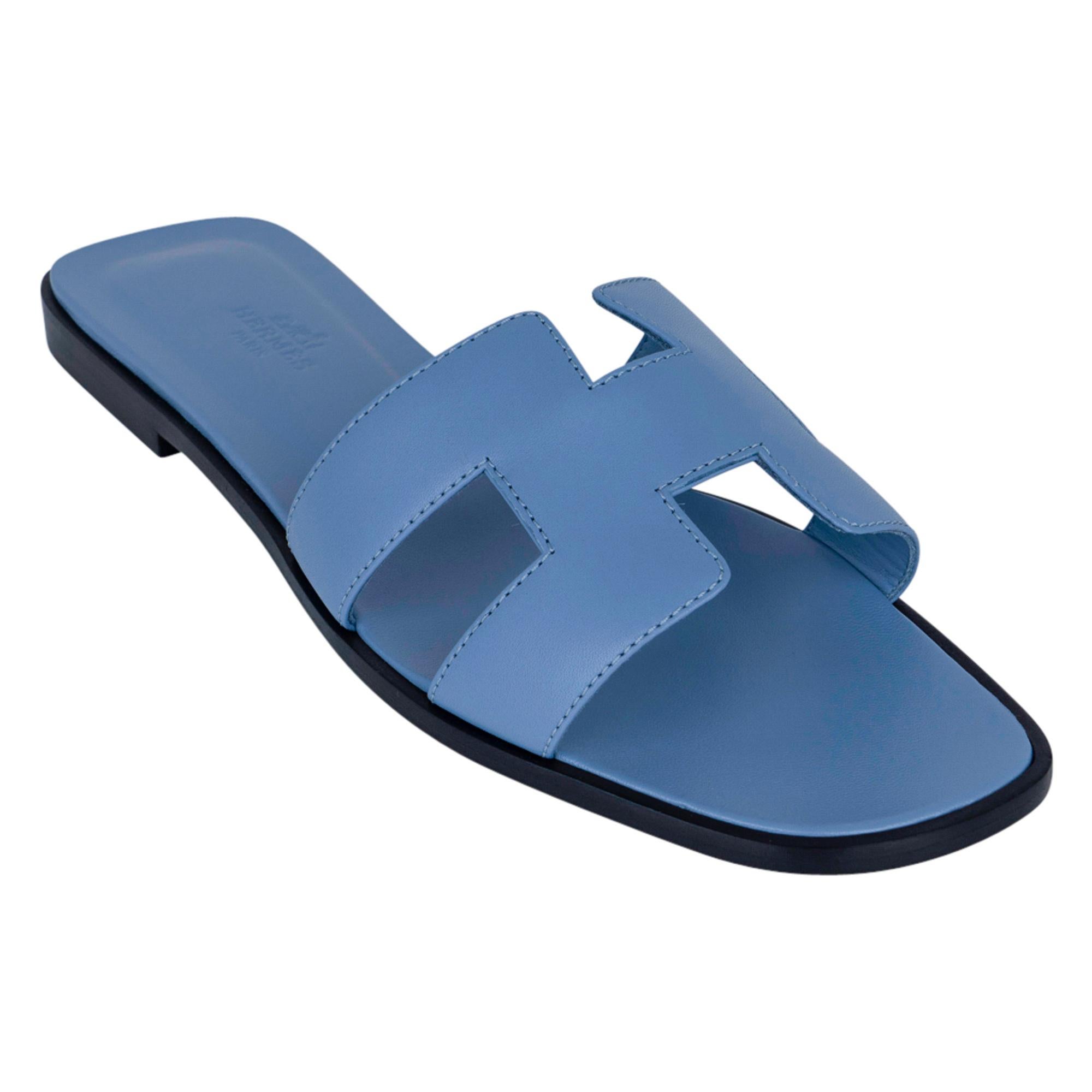 Mightychic offers a pair of Hermes Oran flat sandals featured in beautiful Bleu Bleuet.
These neutral blue slides are a must for foot flirting!
Hermes Paris embossed leather insole. 
Wood heel with leather sole. 
Comes with sleepers and and
