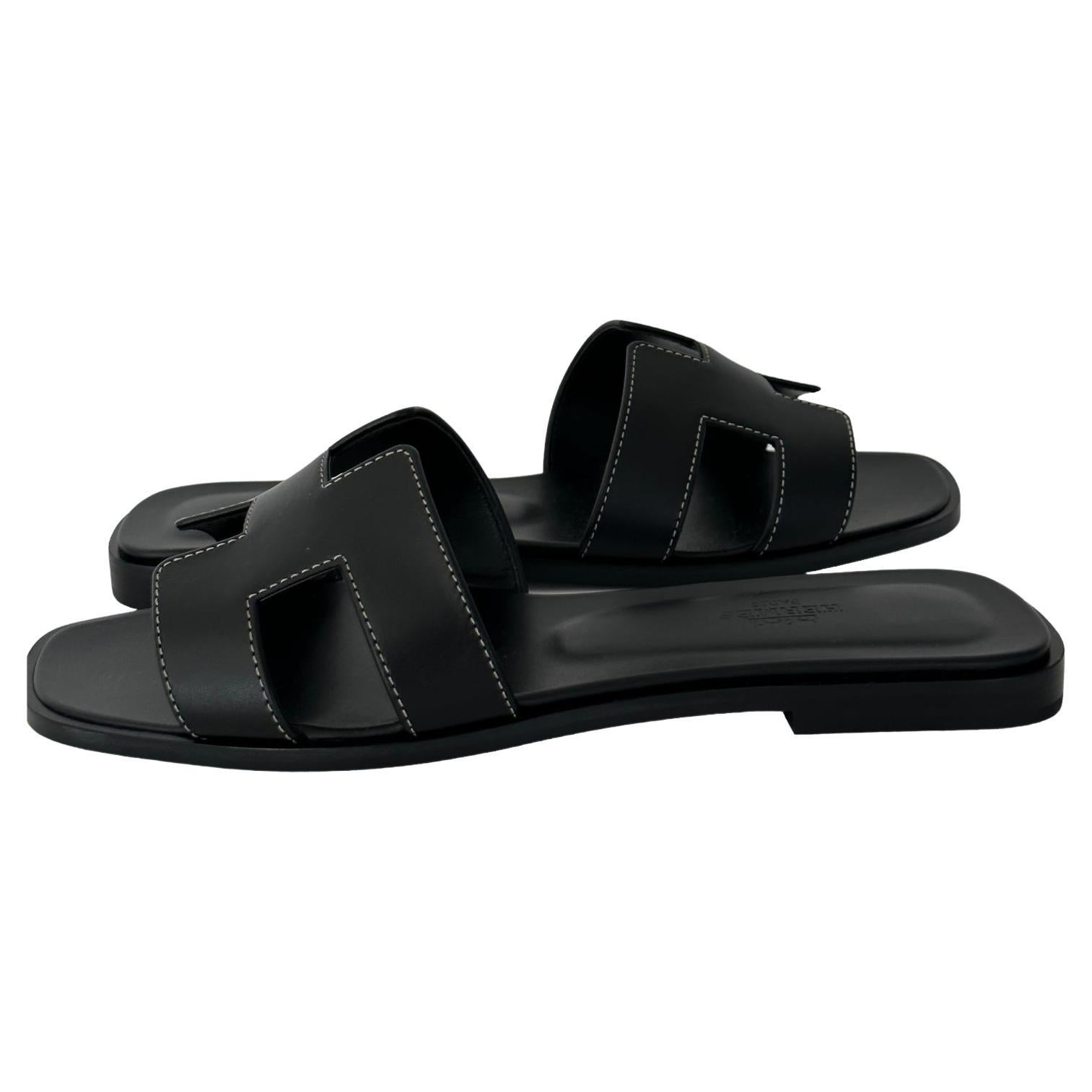 The  Oran Sandal 
Hermes Oran is a style of sandal produced by the luxury fashion brand Hermes. The sandal features a simple, minimalist design, with a leather upper and a flat sole. The Oran is available in a range of colors and materials, and is