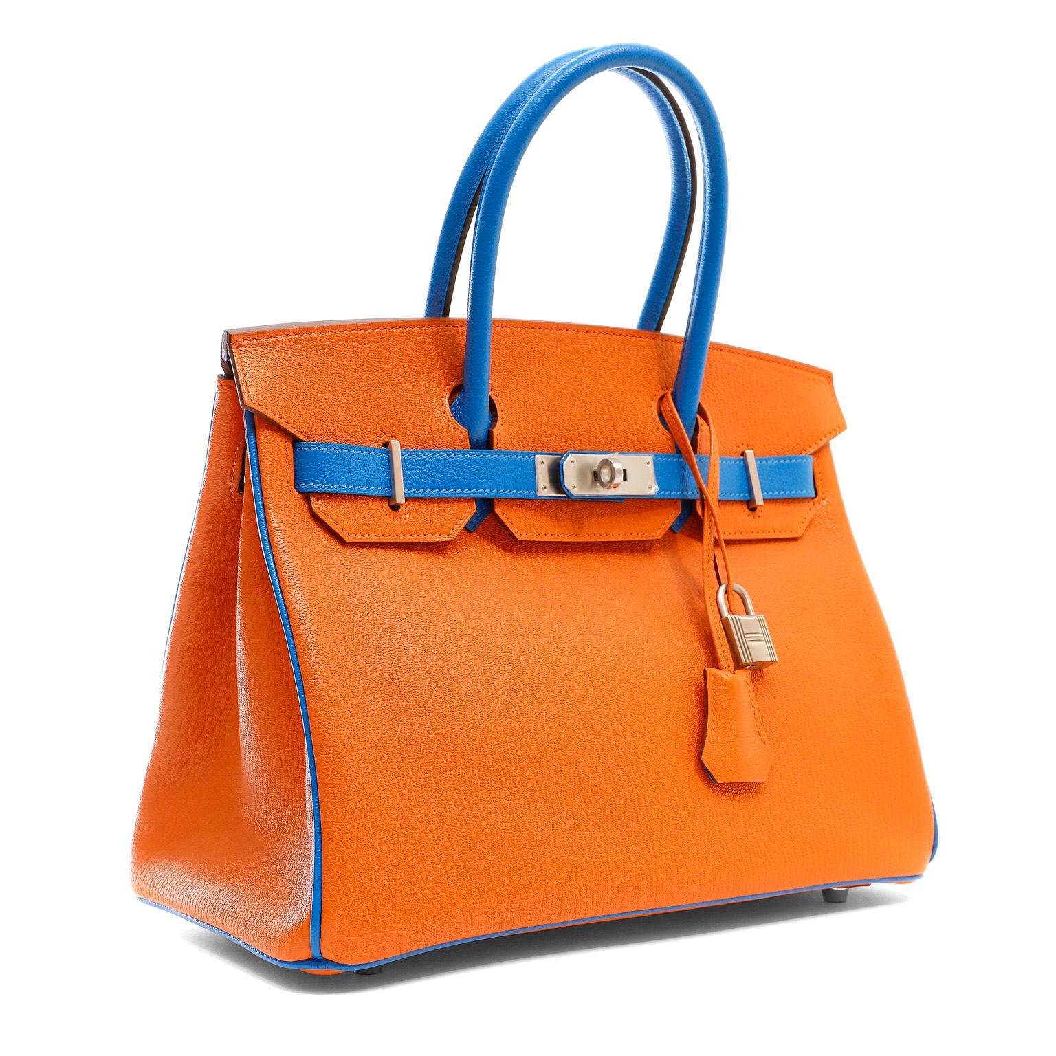 This authentic Hermès Orange and Blue Horseshoe Chevre 30 cm Birkin is in pristine condition with the protective plastic on the specially ordered bushed Palladium hardware.  This combination is a special order, denoted by the horseshoe symbol on the