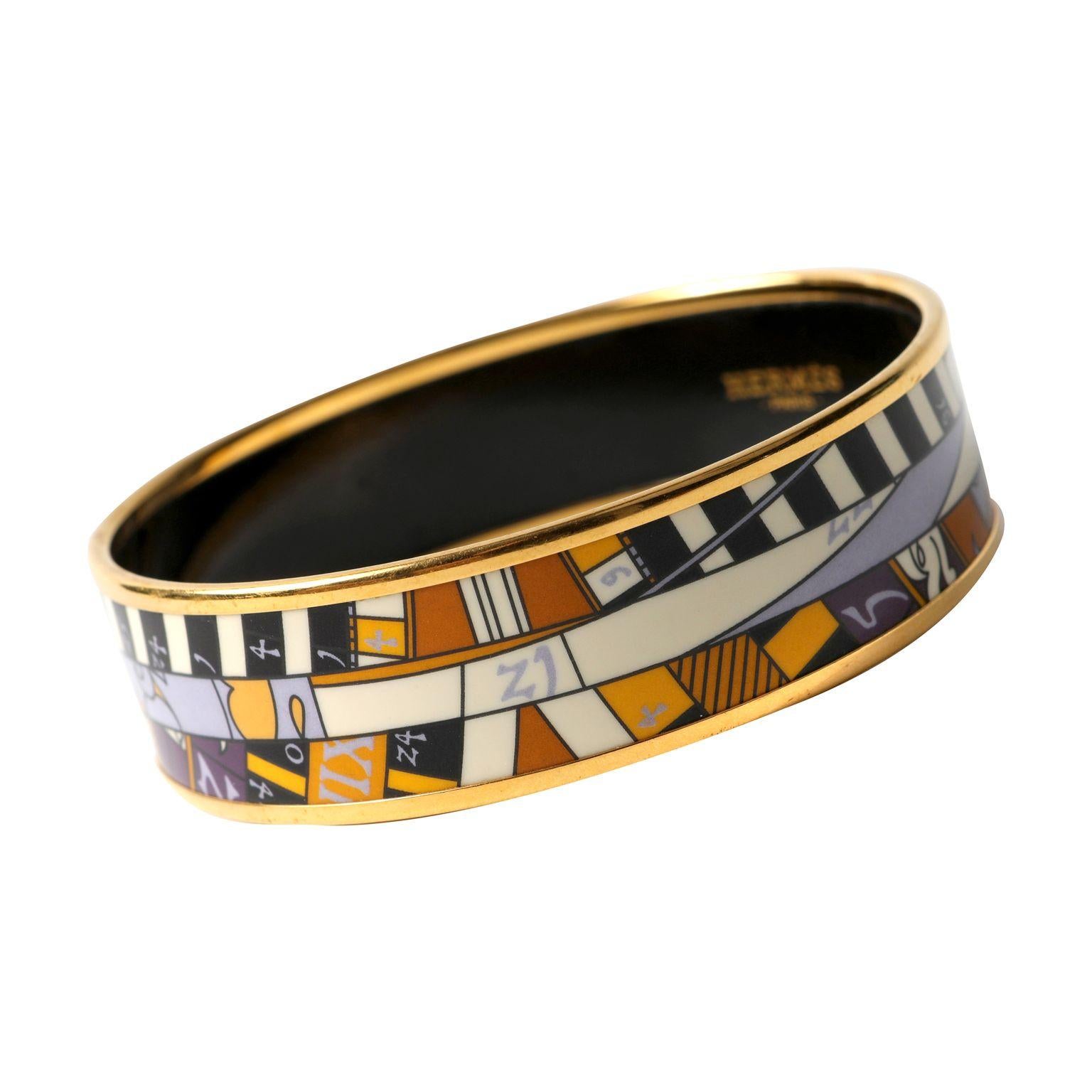 This authentic Hermès Orange and Purple Enamel Bangle is in excellent condition.  Enamel printed bangle with gold hardware.  Size 65.  Pouch or box included.

PBF 13872

