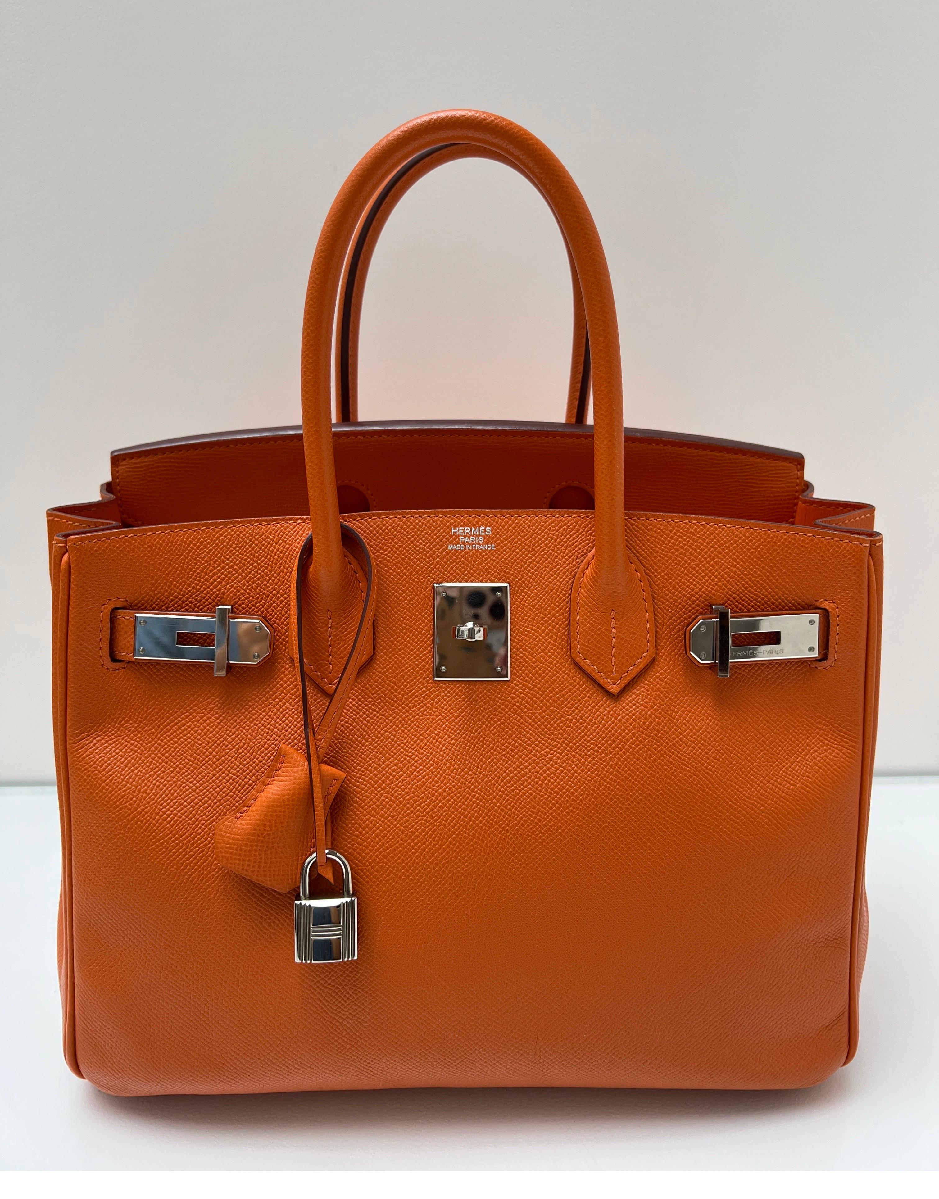Hermes Orange Birkin 30 Bag. Excellent condition. Plastic is still on the hardware. Interior clean. Looks like a new bag. Epsom leather. Palladium silver hardware. Priced to sell quickly. Don't let this one go. Most wanted size 30 and classic Hermes