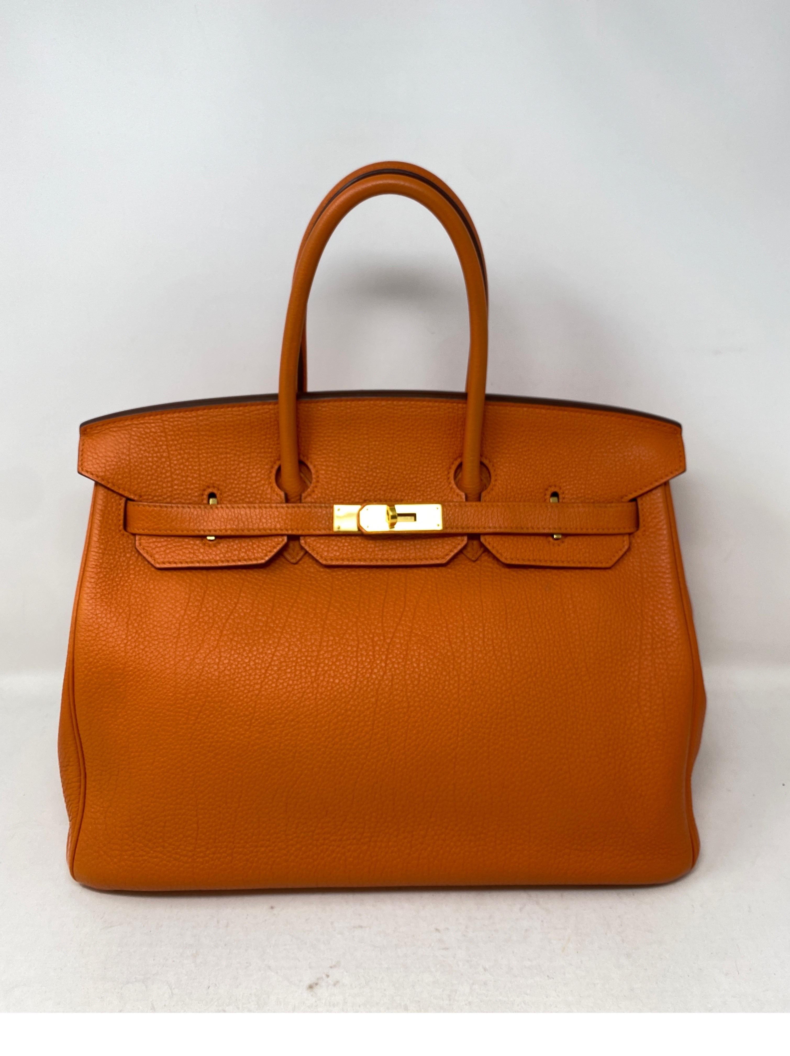 Hermes Orange Birkin 35 Bag. Excellent condition. Togo leather. Bright and beautiful orange classic color. Most wanted color combo with gold hardware. Includes clochette, lock, keys, and dust cover. Guaranteed authentic. 