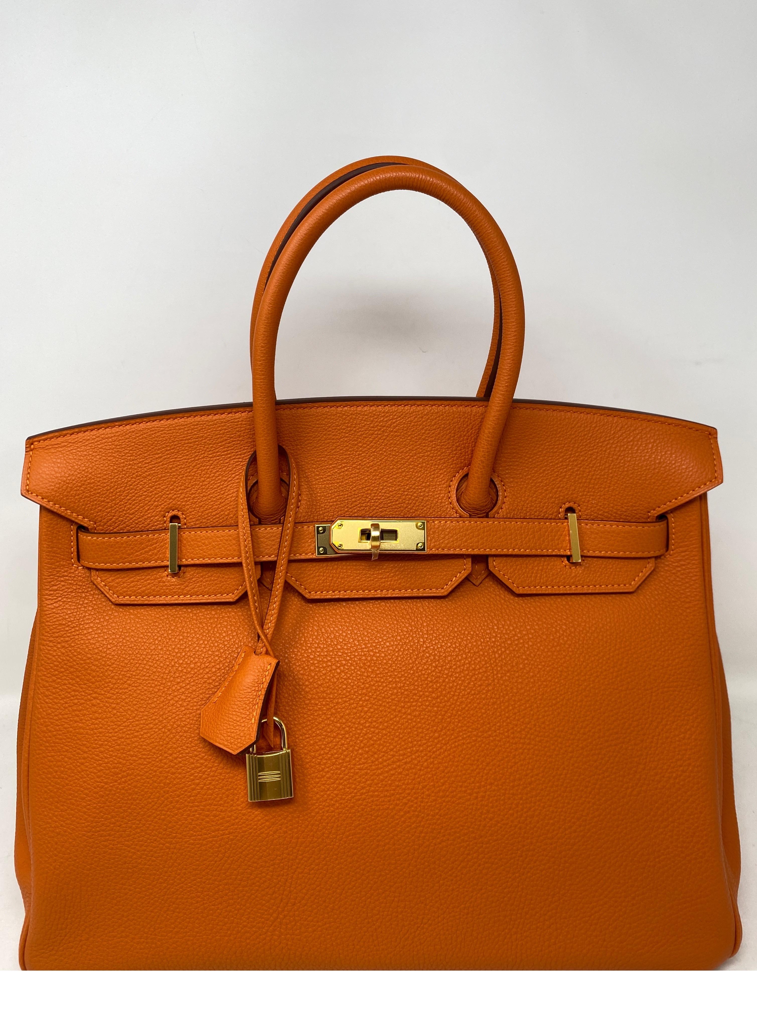 Hermes Orange Birkin 35 Bag. Most wanted combination. Classic Hermes orange togo leather with gold hardware. Excellent condition like new. Still has the plastic on the hardware. Interior pristine. Looks like it was never used. Corners show no wear.