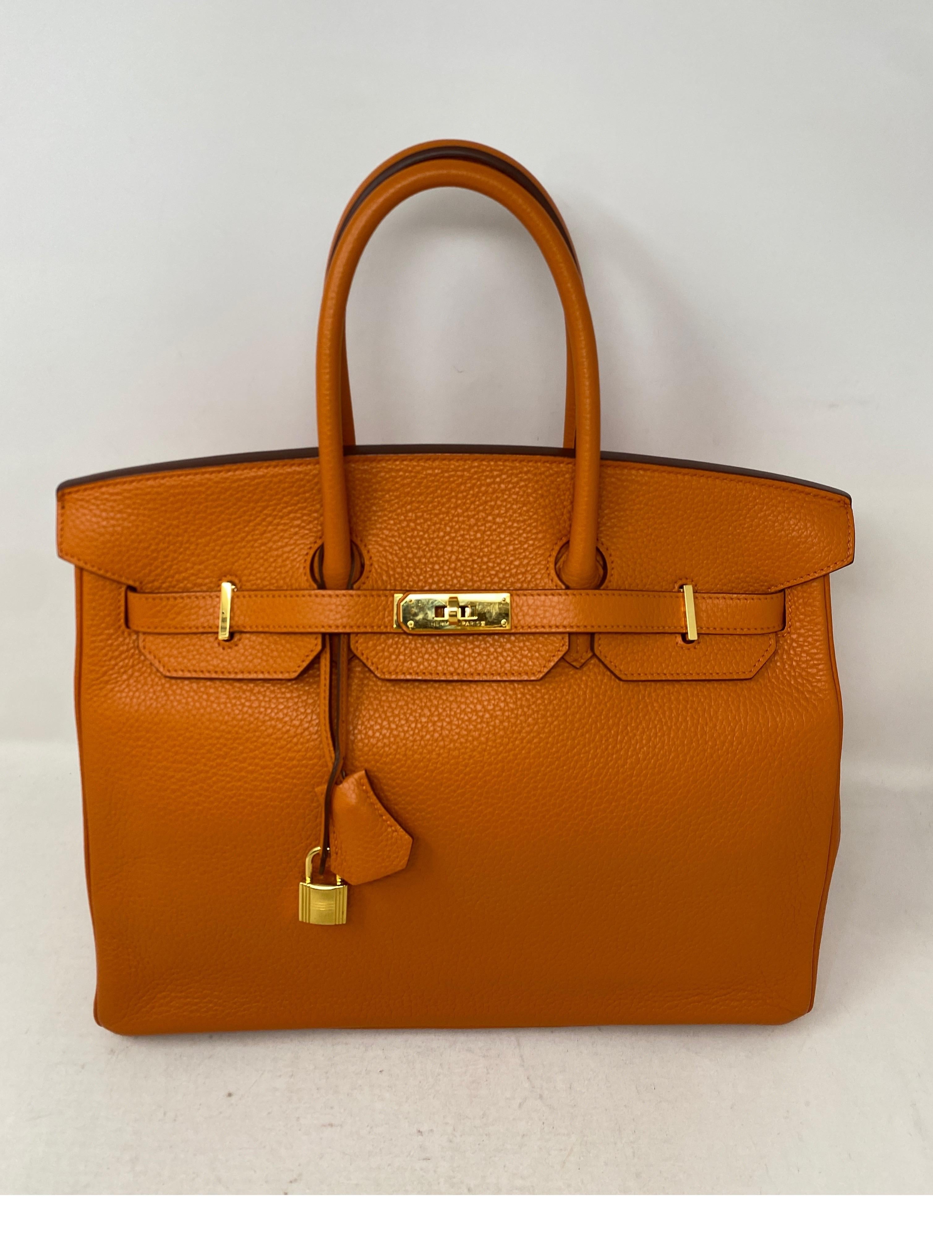 Hermes Orange Birkin 35 Bag. Clemence leather. Gold hardware. Classic Hermes Orange. Good condition. T square stamp. Includes clochette, lock, keys, and dust bag. Add to your collection. Guaranteed authentic. 