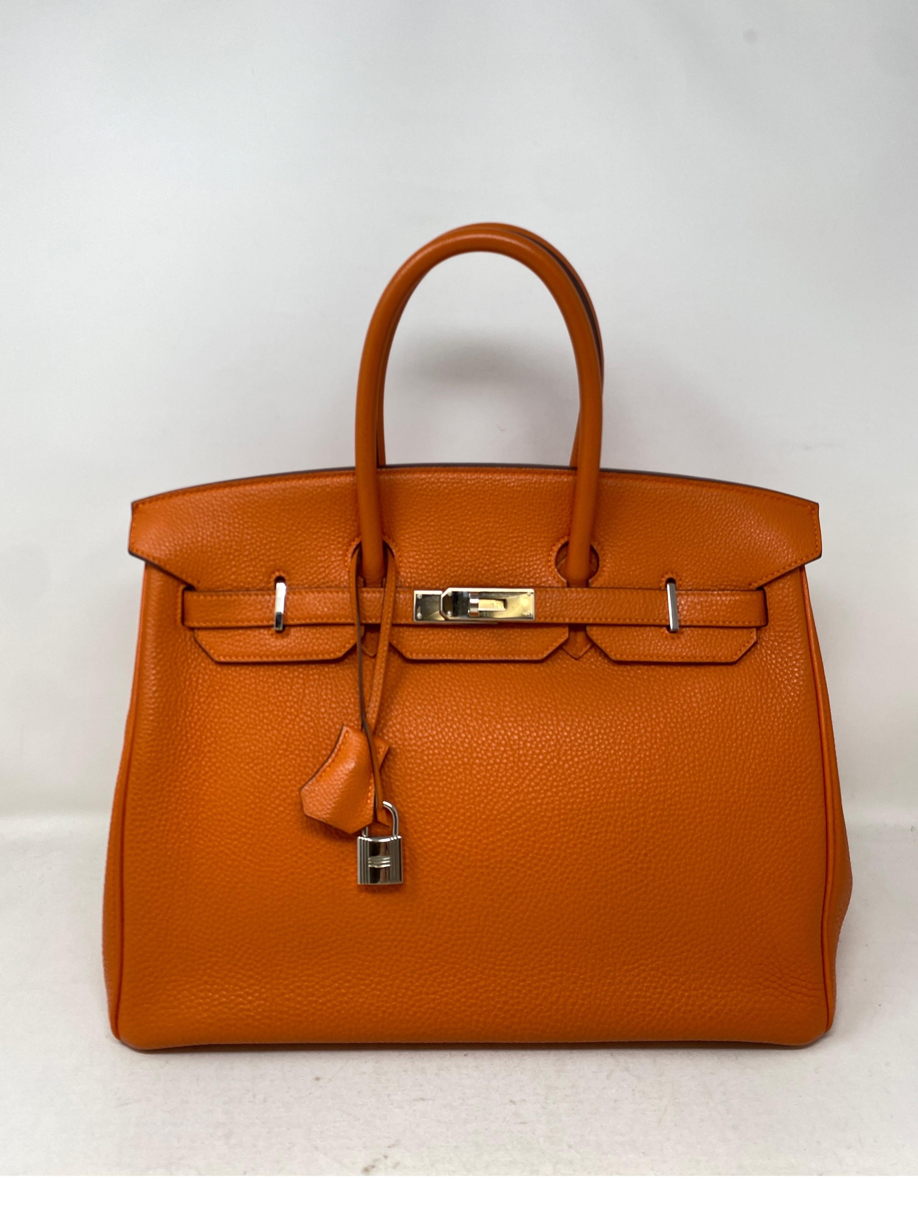 Sac Hermes Birkin 35 orange. Couleur orange classique d'Hermès avec quincaillerie en palladium argenté. Bon état. Intérieur propre. Comprend une clochette, un cadenas, des clés et un sac à poussière. Garantie d'authenticité. 