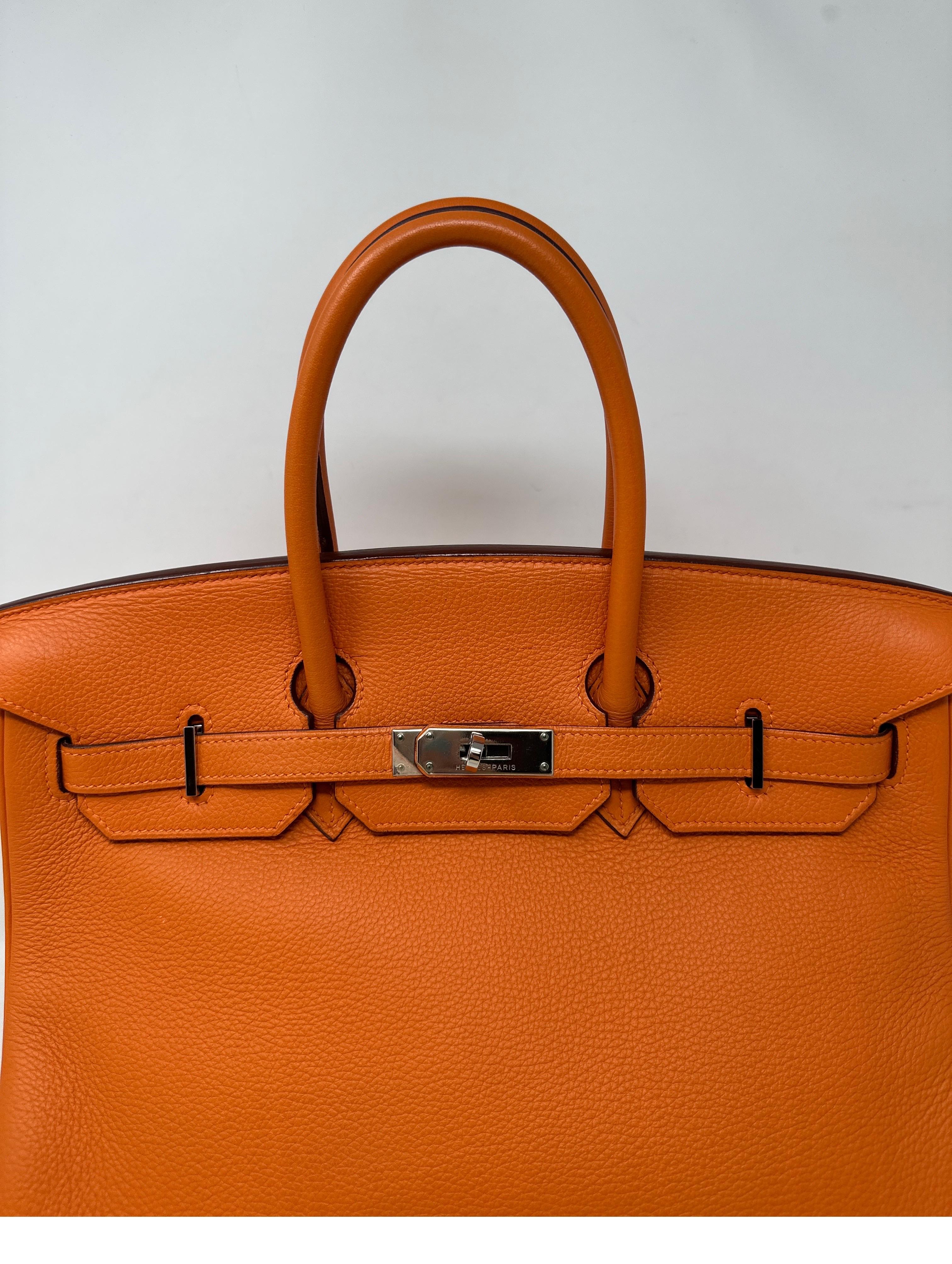 Hermes Orange Birkin 35 Bag. Excellent condition. Palladium hardware. Interior clean. Looks like new. Classic orange color from Hermes. Includes clochette, lock, keys, and dust bag. Guaranteed authentic. 
