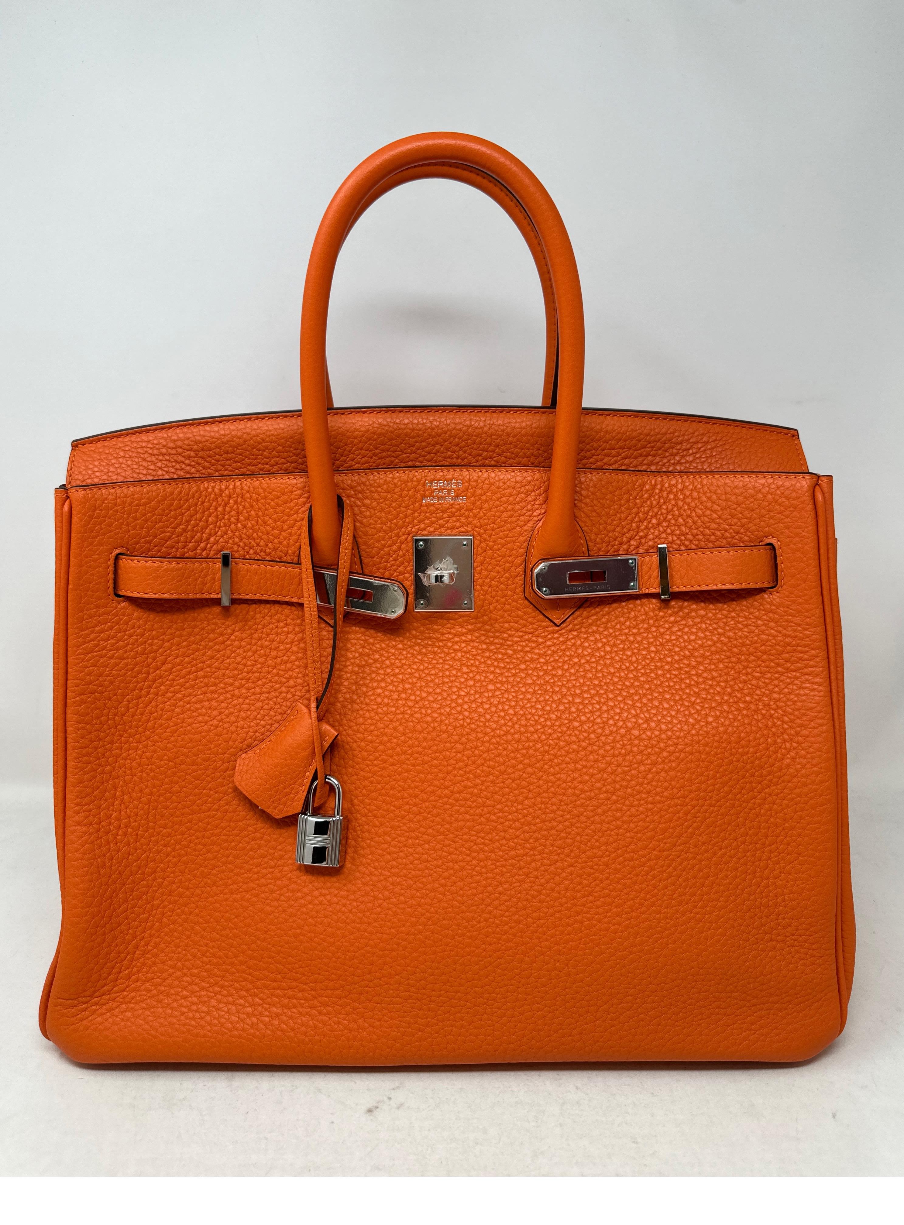 Hermes Orange Birkin 35 Bag. Palladium silver hardware. Excellent condition. Clemence leather. Interior clean. Plastic is still on hardware. Classic original Hermes orange color. Includes clochette, lock, keys, and dust bag. Guaranteed authentic. 