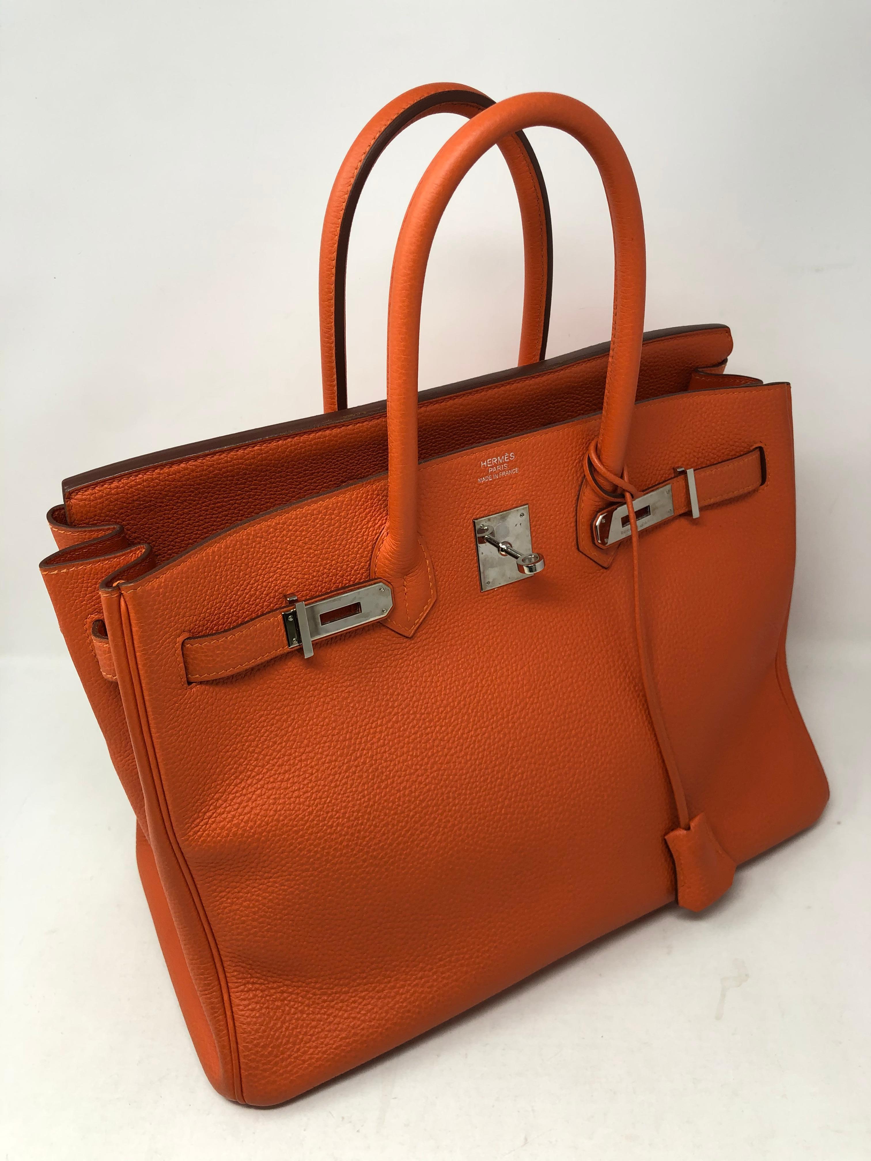 Hermes Orange Birkin 35 Togo leather. Palladium hardware. Excellent condition. The Hermes Orange color. Most wanted combination. Includes the original receipt from 2015. Hermes dust cover, clochette, lock and keys included. Beautiful orange togo