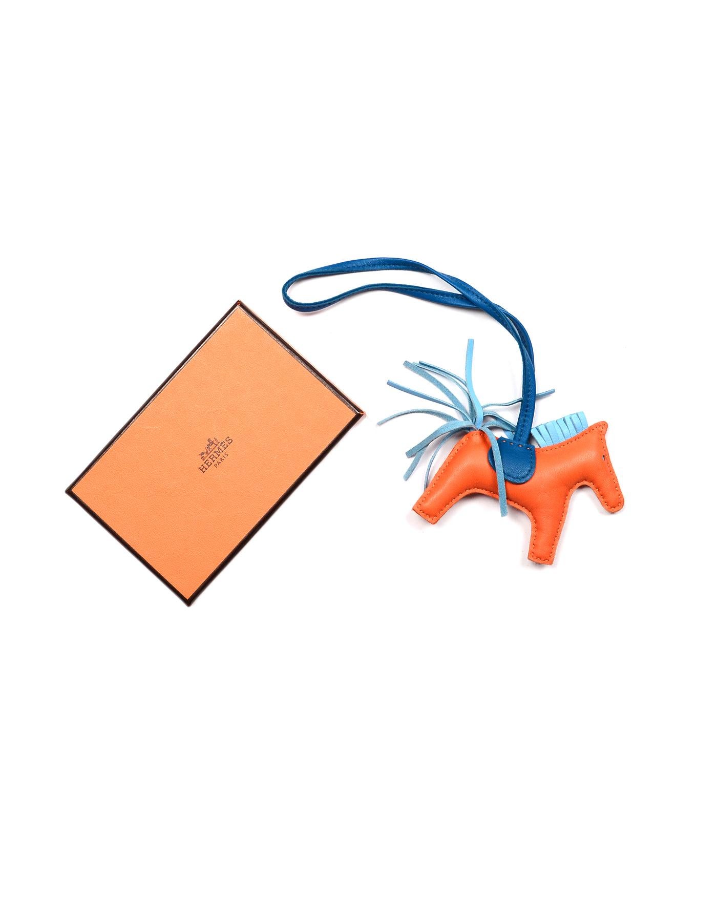 Hermes Orange/Blue Leather Rodeo Horse/Pony PM Bag Charm,
Pictured With Item #7306-2 Hermes Black Togo Leather 30CM Birkin Bag PHW

Made In: France
Color: Orange, blue
Materials: Leather
Closure/Opening: Leather strap to loop
Overall Condition: