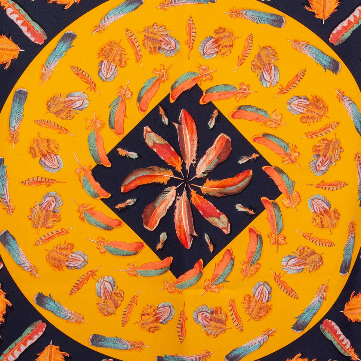 100% authentic Hermes 'Plumes ll 90' scarf by Henri de Linares in Marin (navy blue) silk twill (100%) with Capucine orange border and Jaune D'or (yellow) center. Feather print in orange, red, blue and green. Has been worn and is in excellent