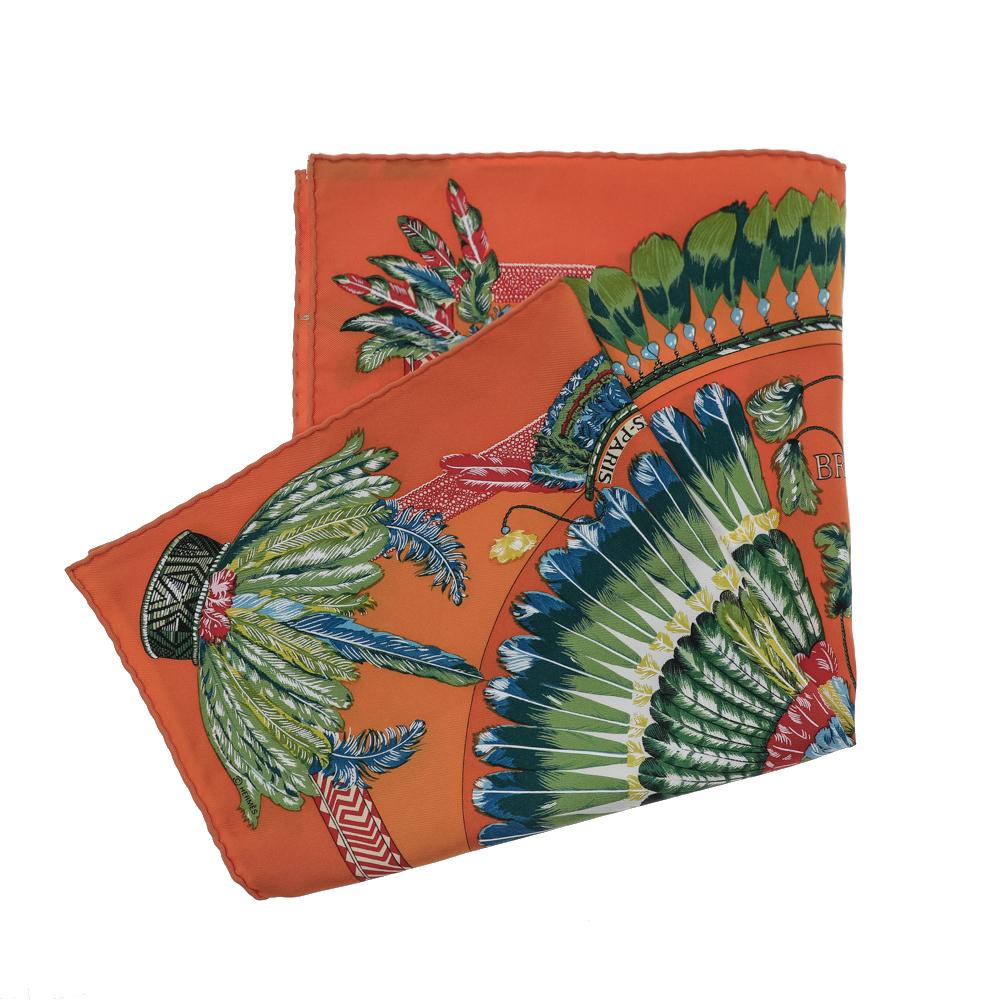Refresh your summer outfits by accessorizing with this beautiful scarf from the House of Hermes. Tailored using orange Brazil silk fabric, this scarf has a squared silhouette measuring 41 cm x 41 cm. Exotic and exuberant, this Hermes scarf will