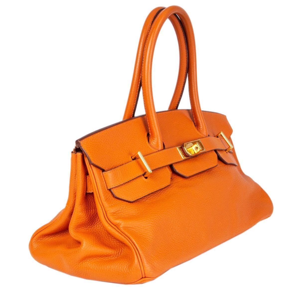 Hermès 'JPG I Shoulder Birkin' bag in orange Taurillon Clemence leather with Palladium hardware. Lined in Chevre (goat skin). Has been carried and is in excellent condition. Lock is missing. Comes with key, clochette and dustbag. 

Height 17cm