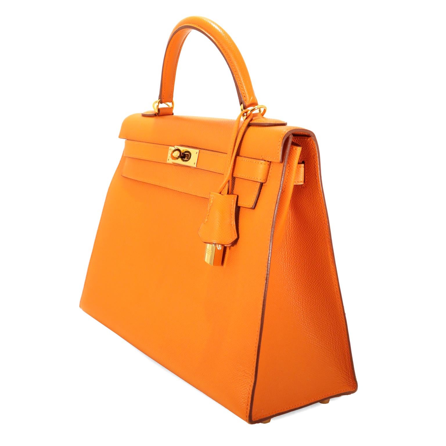 This authentic Hermès Orange Epsom 32 cm Kelly Sellier is in pristine condition.  Hermès bags are considered the ultimate luxury item worldwide.  Each piece is handcrafted with waitlists that can exceed a year or more.  The ladylike Kelly is classic
