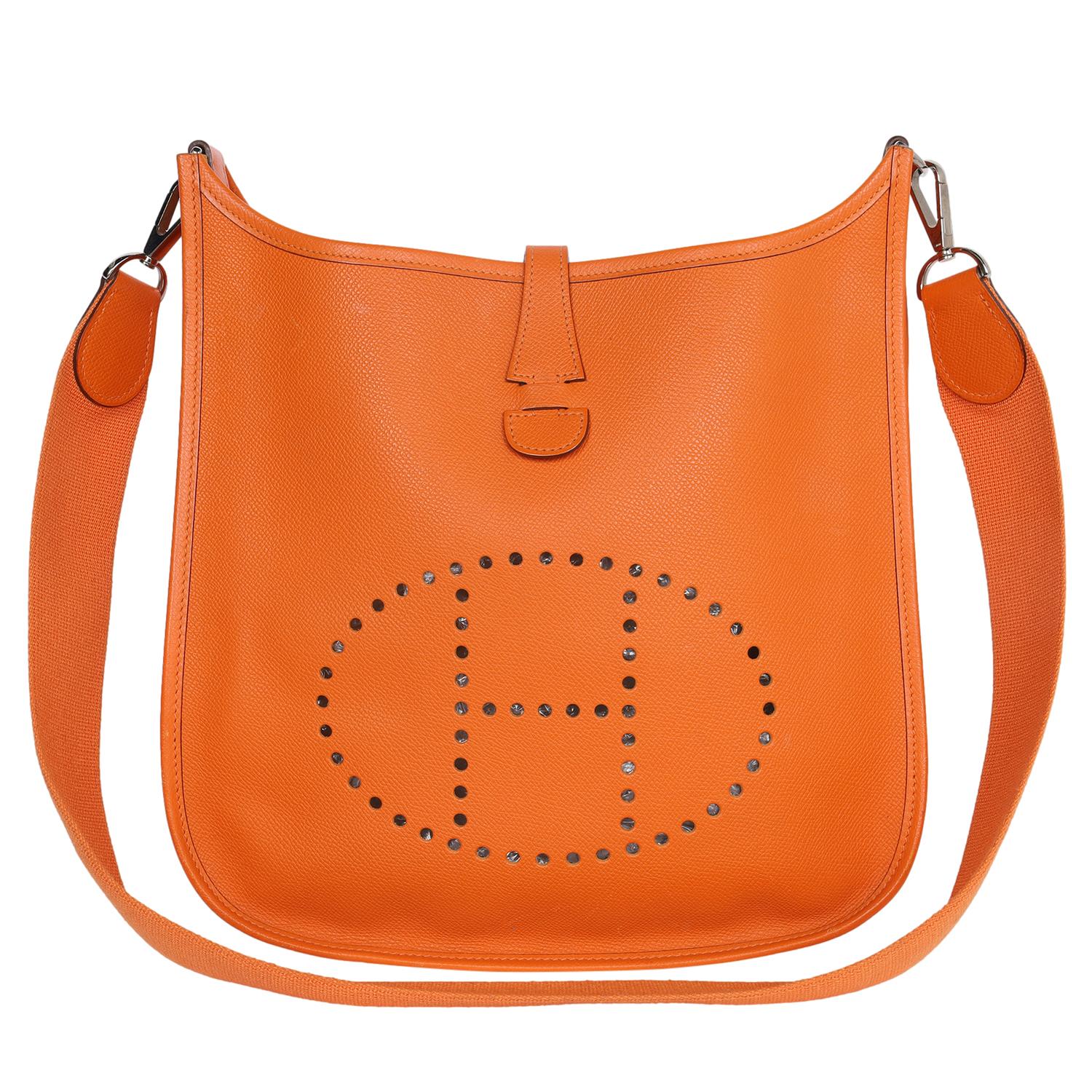Authentic, pre-loved Hermes Orange Leather Evelyne I Shoulder Bag.

Features a perforated logo display on the front, and a flat shoulder strap, the bag can be worn comfortably over the shoulder. The upper opening is secured with the help of a snap