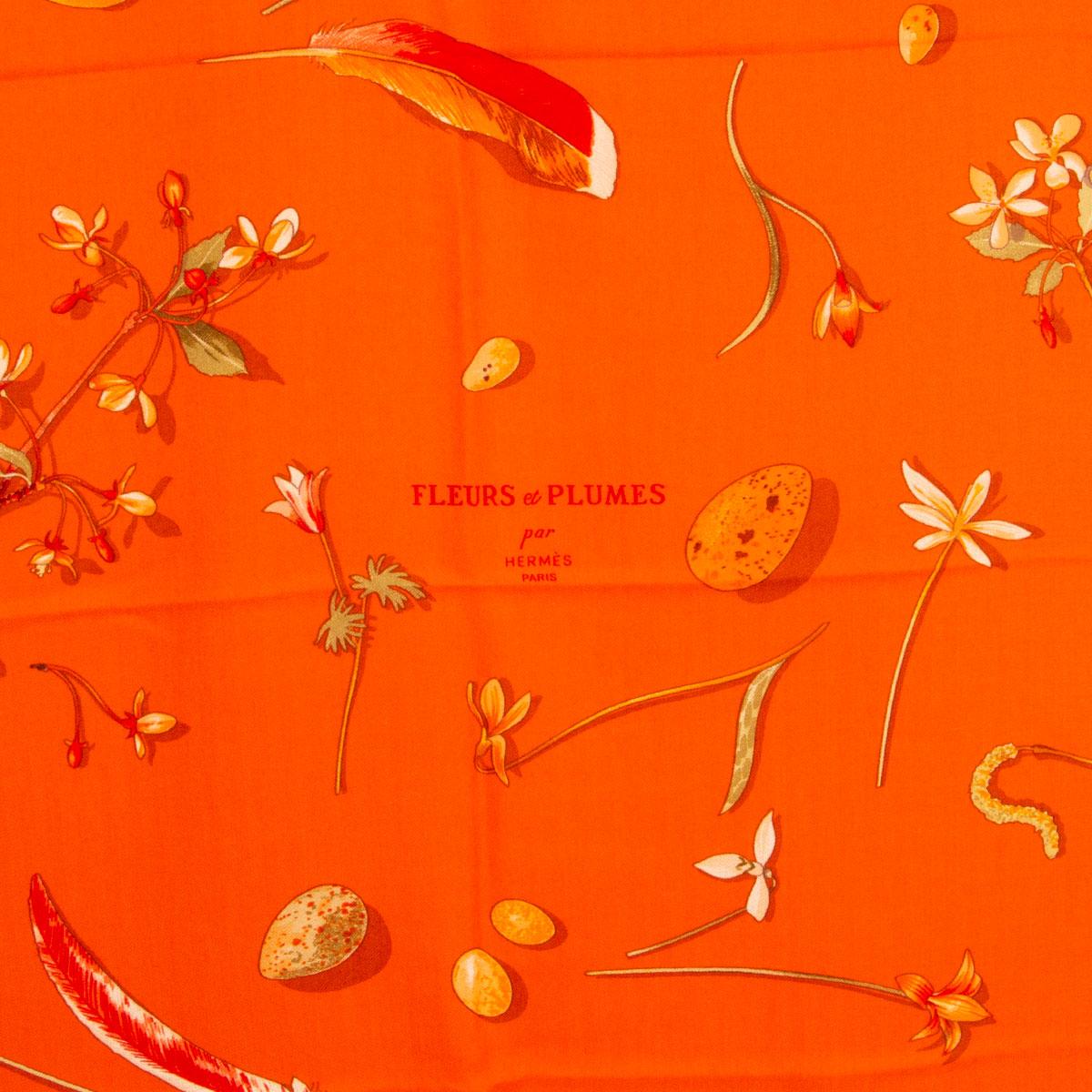 100% authentic Hermes 'Fleurs et Plumes 140' shawl by Leigh P. Cook in orange cashmere (65%) and silk (35%) with details in green and various shades of orange. Has been worn and is in excellent condition.

Width 140cm (54.6in)
Height 140cm