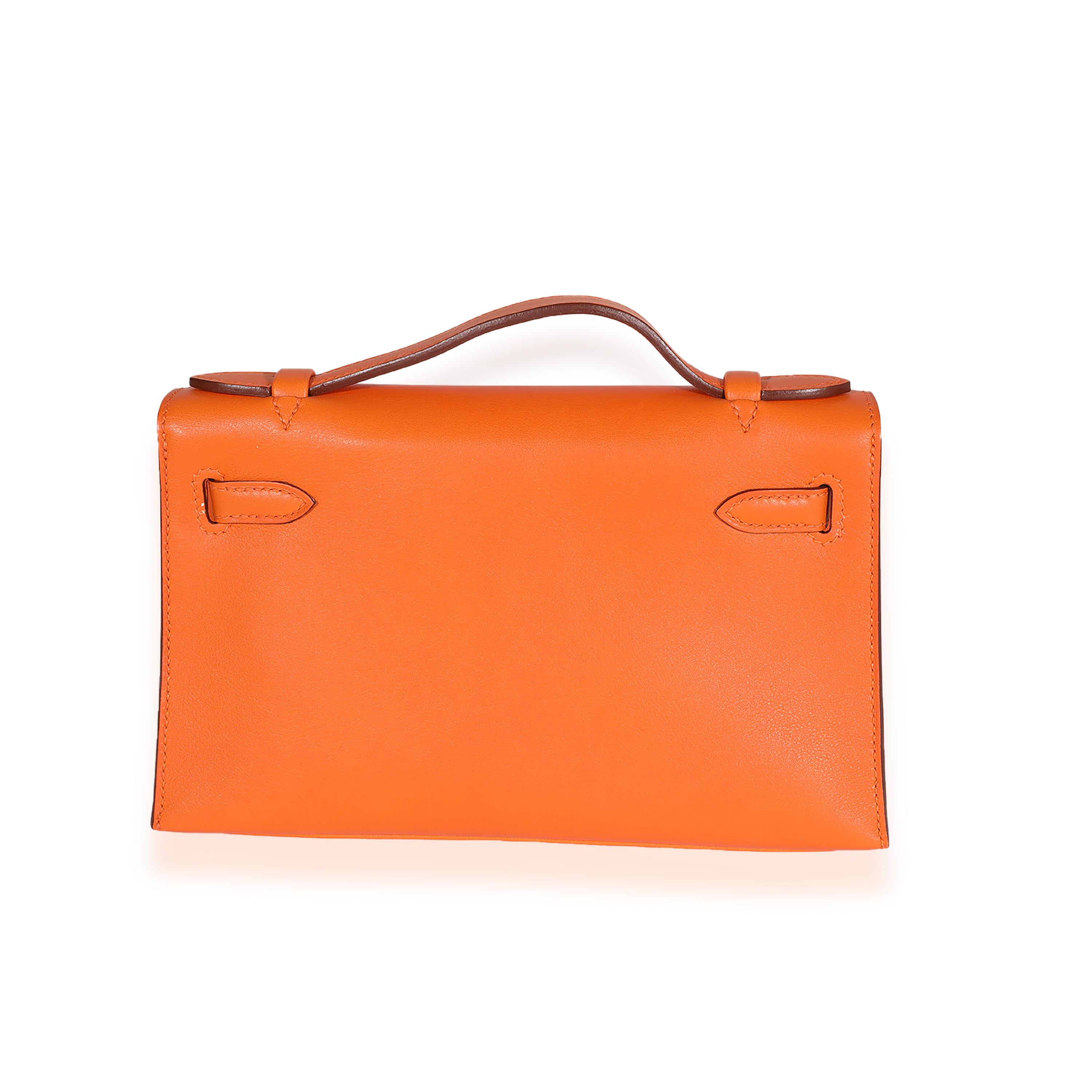 Listing Title: Hermès Orange H Swift Kelly Pochette GHW
SKU: 122817
Condition: Pre-owned 
Handbag Condition: Excellent
Condition Comments: Excellent Conditions. Scuffing at exterior. Plastic at hardware. No other signs of wear.
Brand: Hermès
Model: