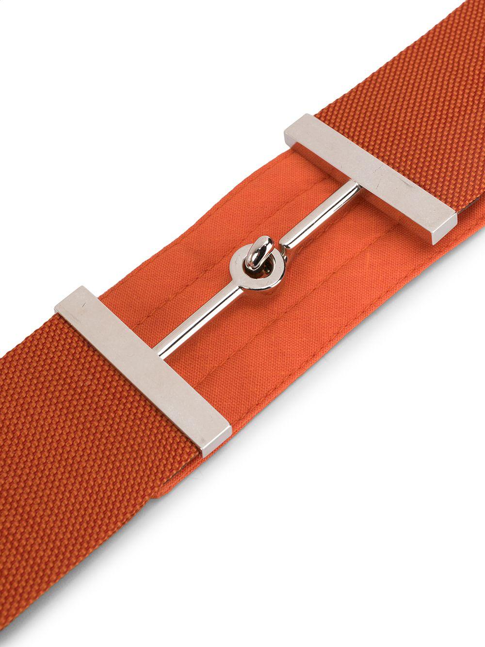 Crafted in France from a vibrant orange cotton-blend, this pre-owned belt by Hermès features a hook and eye fastening and a horsebit buckle accented by silver-toned metal hardware.

Colour: Orange/ Silver

Composition: Cotton/ Silver-plated