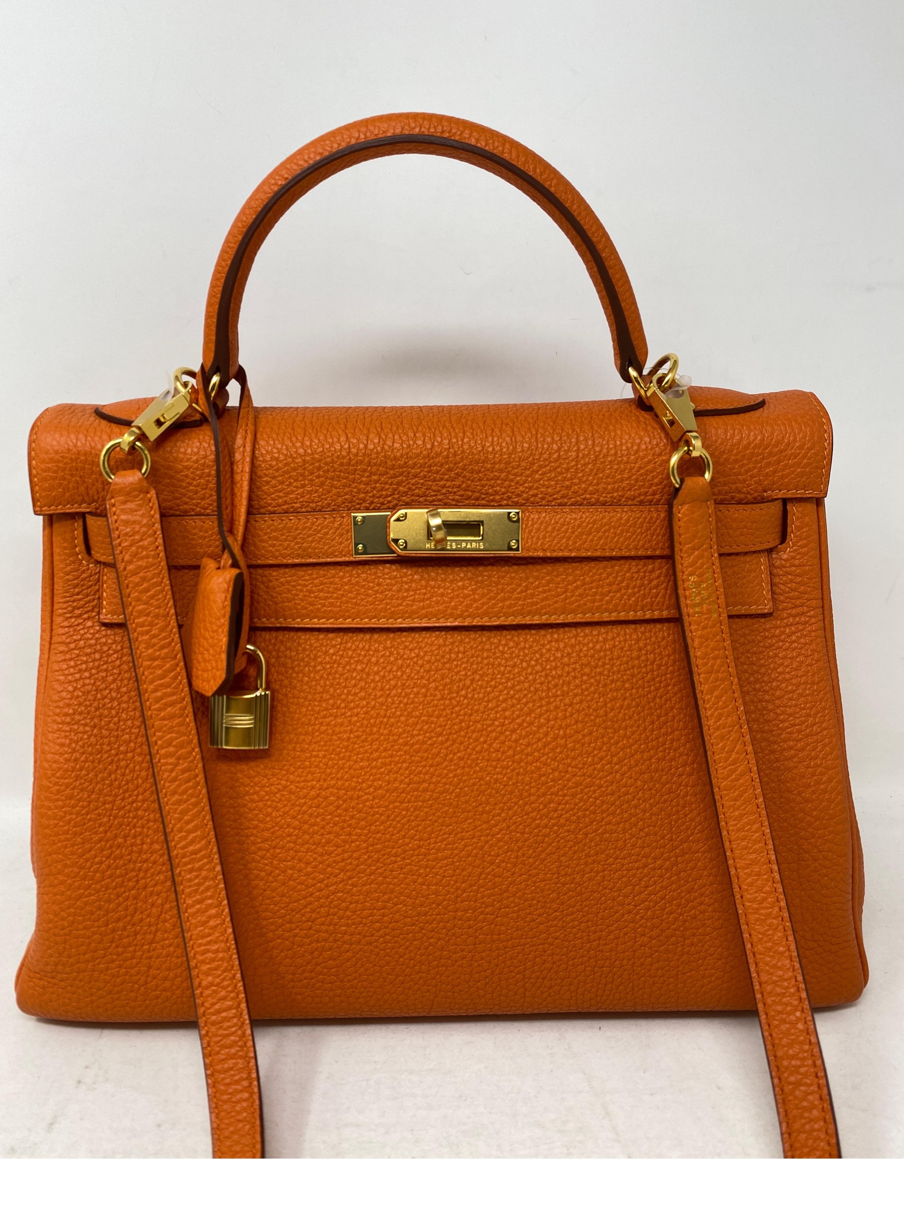 Hermes Orange Kelly 32 Bag. Excellent like new condition. Gold hardware. Hard to find size Kelly. Classic orange color. Includes clochette, lock, keys, and dust cover. Guaranteed authentic. 