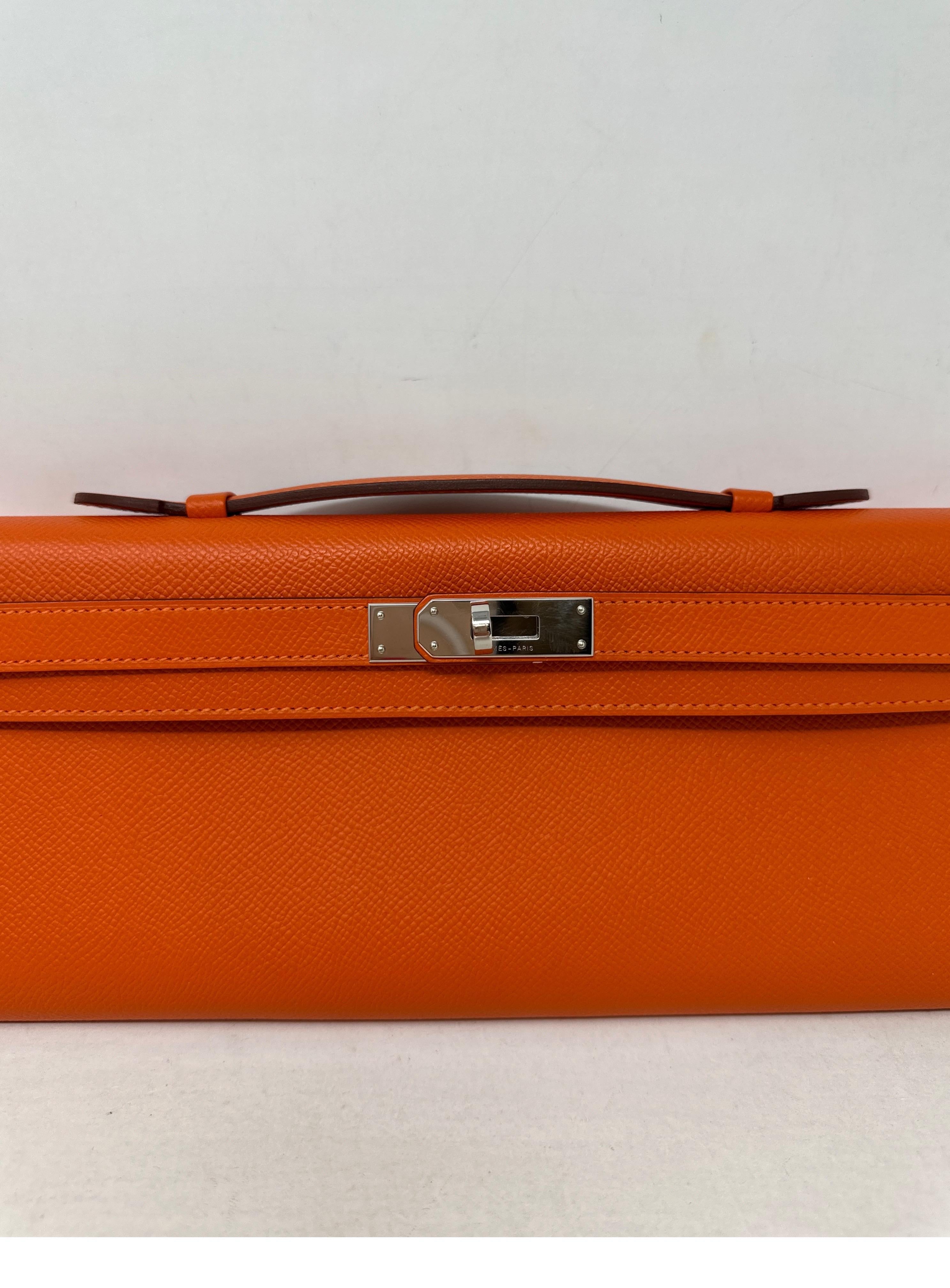 Hermes Orange Kelly Clutch Bag. Epsom leather. Excellent condition. Looks like new. Palladium silver hardware. Interior clean. Retired Kelly clutch. Includes dust bag and box. Guaranteed authentic. 
