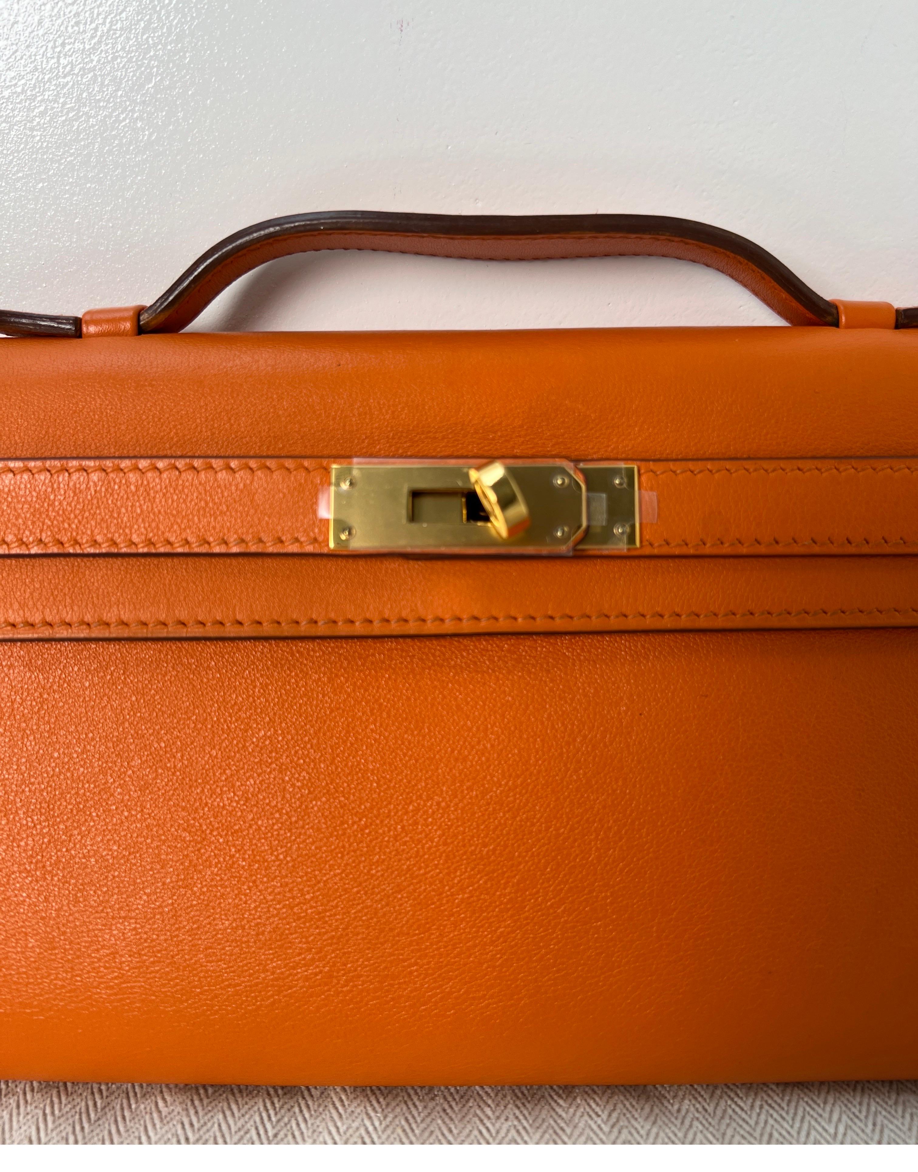 Hermes Orange Kelly Cut Clutch Bag. Excellent condition. Gold hardware. Retired clutch from Hermes. Highly collectible. Interior clean. Will great a great gift to an Hermes fan. Includes dust bag and box. Guaranteed authentic. 