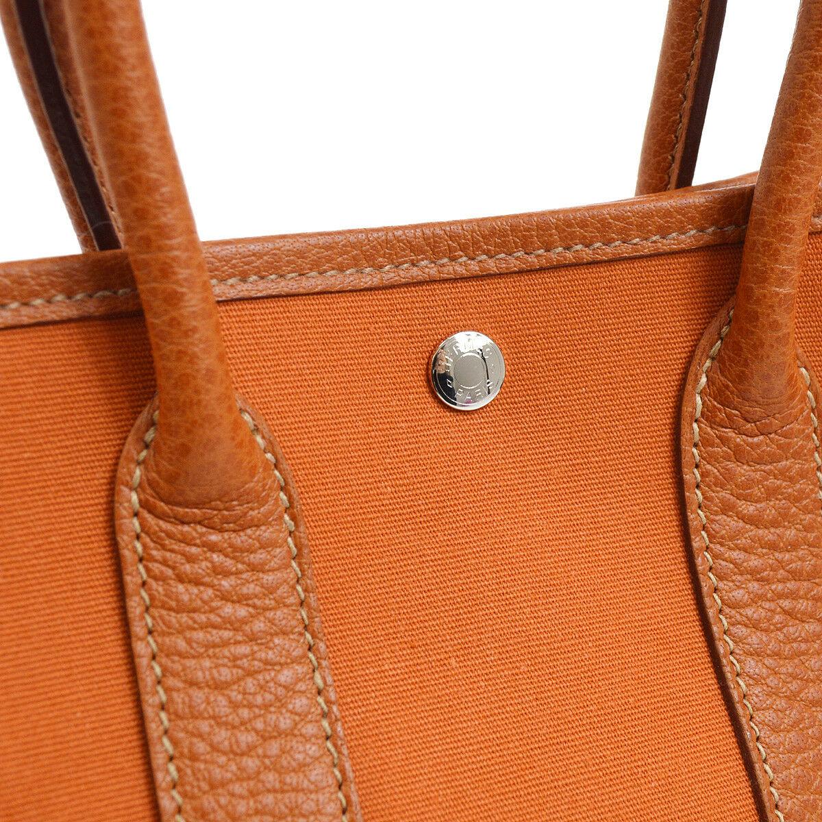 Hermes Orange Leather Canvas Top Handle Satchel Mini Garden Small Tote Bag in Box

Canvas
Leather
Woven lining
Snap closure
Silver tone hardware
Date code present
Made in France 
Handle drop 4