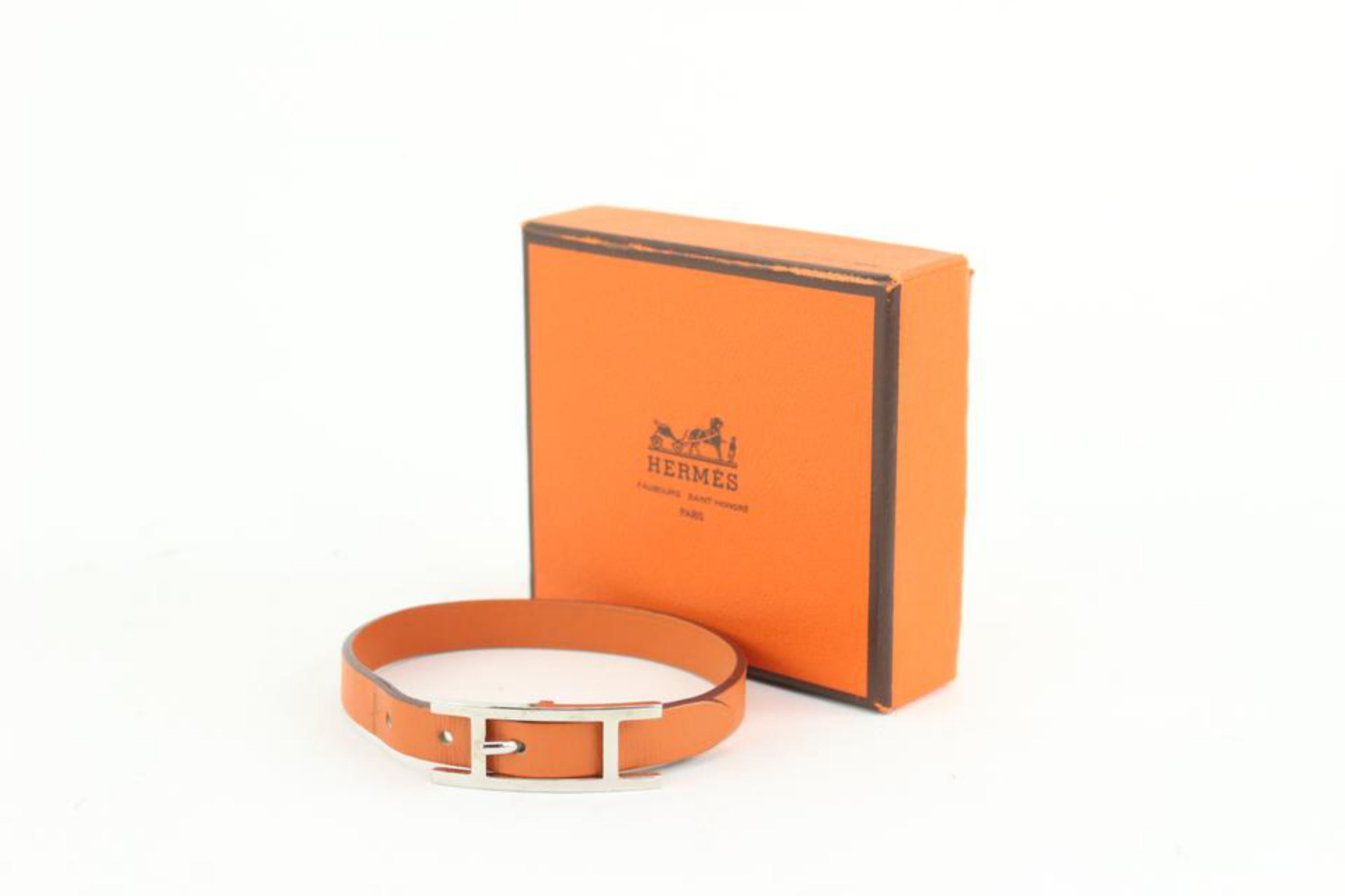 Hermès Orange Leather Silver H Api Bracelet 16h23
Date Code/Serial Number: J in a Square
Measurements: Length: 2.2